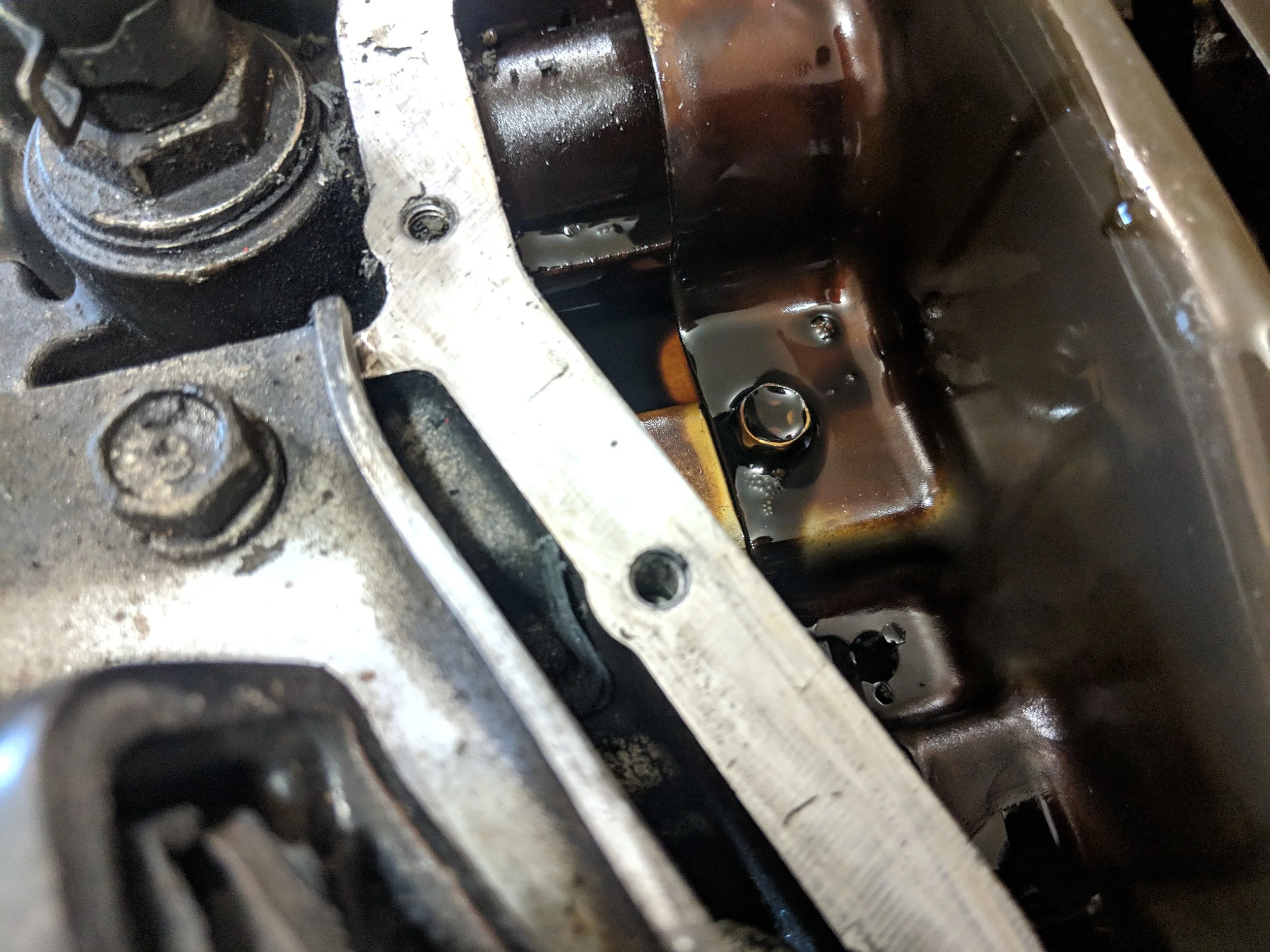 Cleaning off the gasket mating surface, while being careful to keep silicone out of the engine.