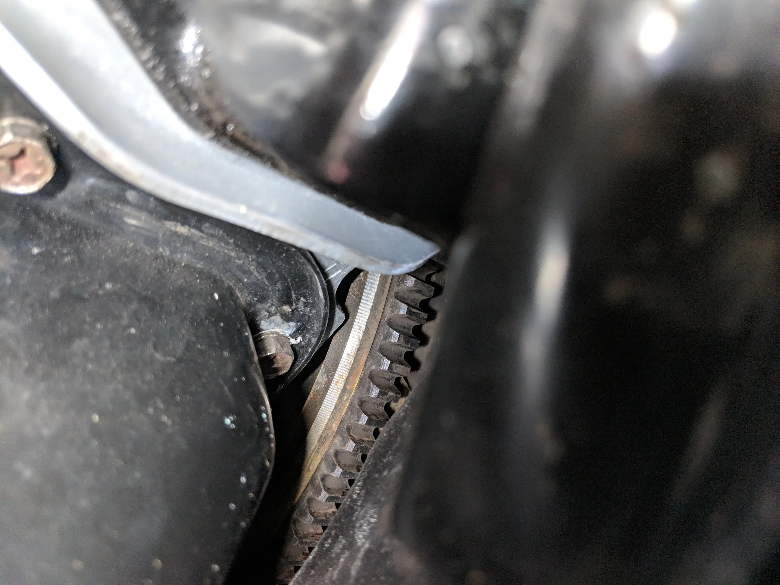 There is one of the four bolts, very well tucked behind everything.