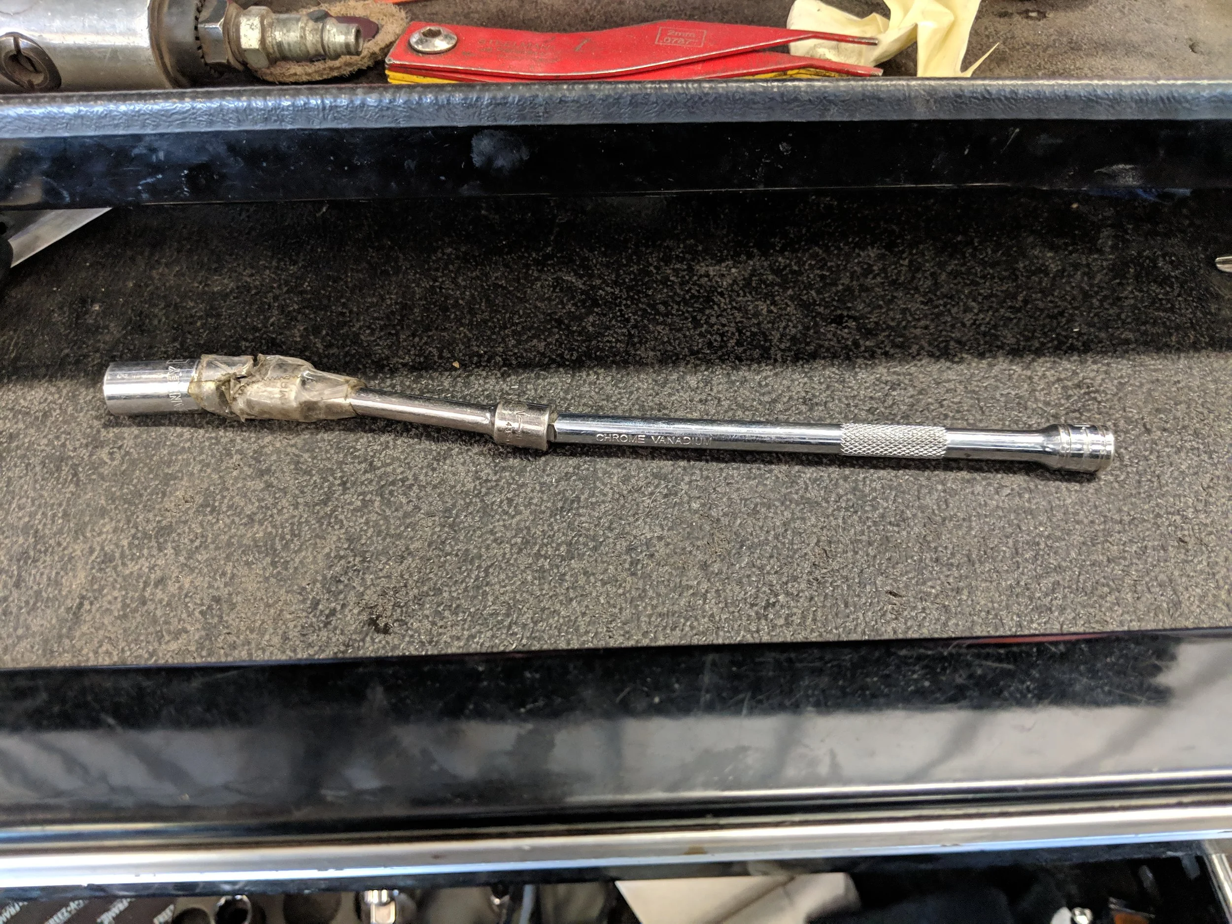 My crazy tool setup for the oil pan removal when on the car. It works very well, the tape is there to keep it from moving too far. Works like a dream as there are two bends to move past.
