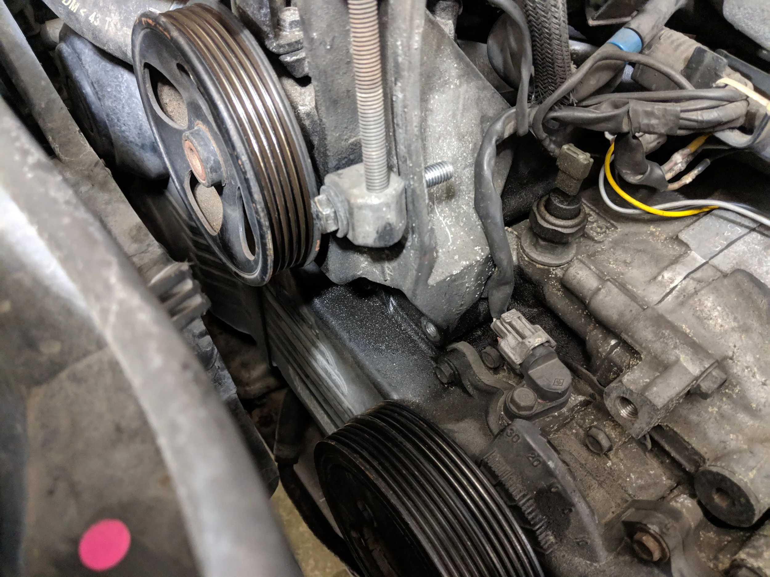 The power steering tensioner is one bolt to hold onto the Alternator. The top bolt loosens and tightens the tension.