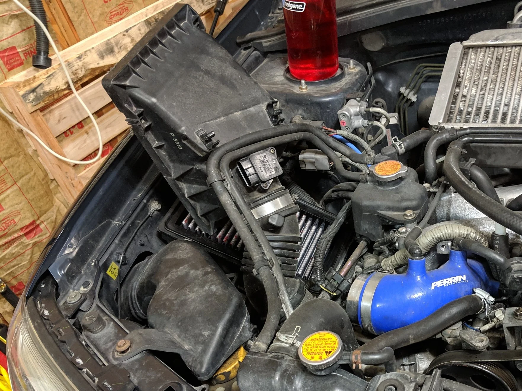 Undoing the clips and clamp on the turbo inlet will allow you to pop the intake hose and upper box off.