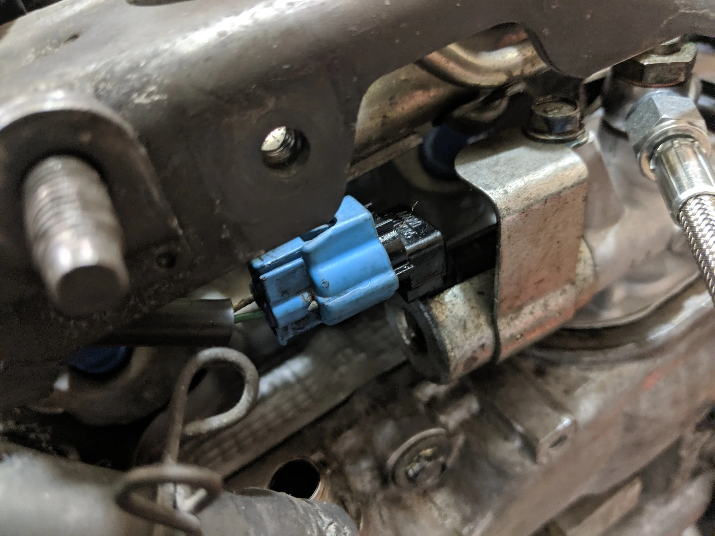 Passenger side OCV solenoid is located behind the power steering hose brackets. Remove this connection.