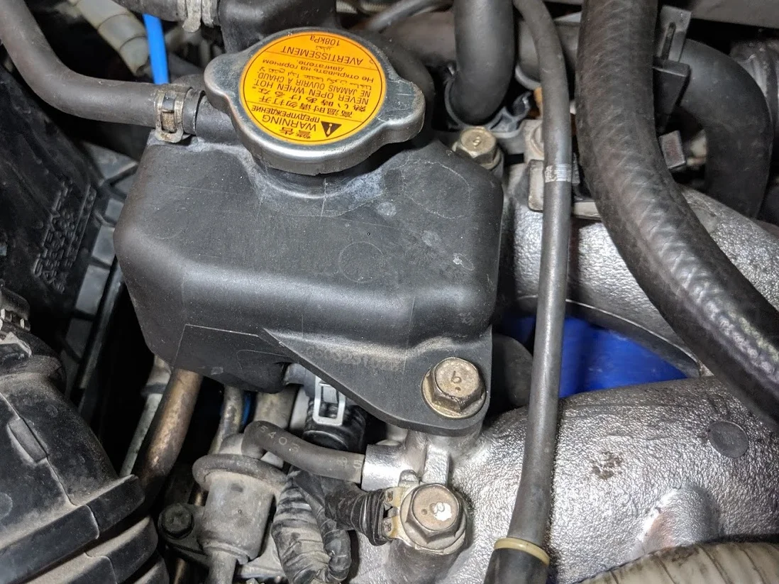 Remove the two bolts on the manifold. This is a great time to remove the rubber line that ties to the boost controller Then remove the clamp you can just see. or you can remove the lower clamp not seen in this photo.