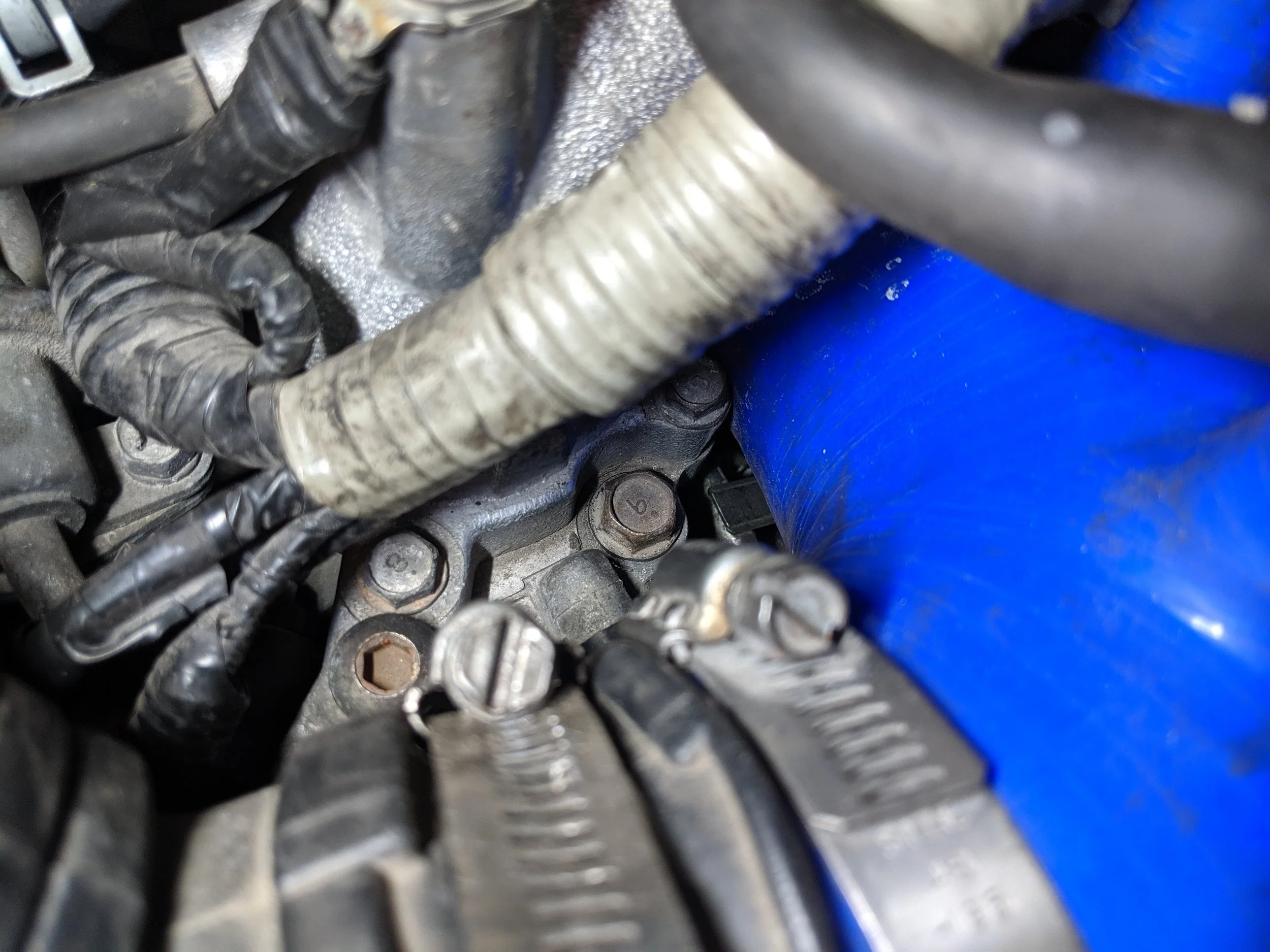 The bolt to the right nearest the turbo inlet needs to be removed. It passes through both the TGVs and intake manifold.