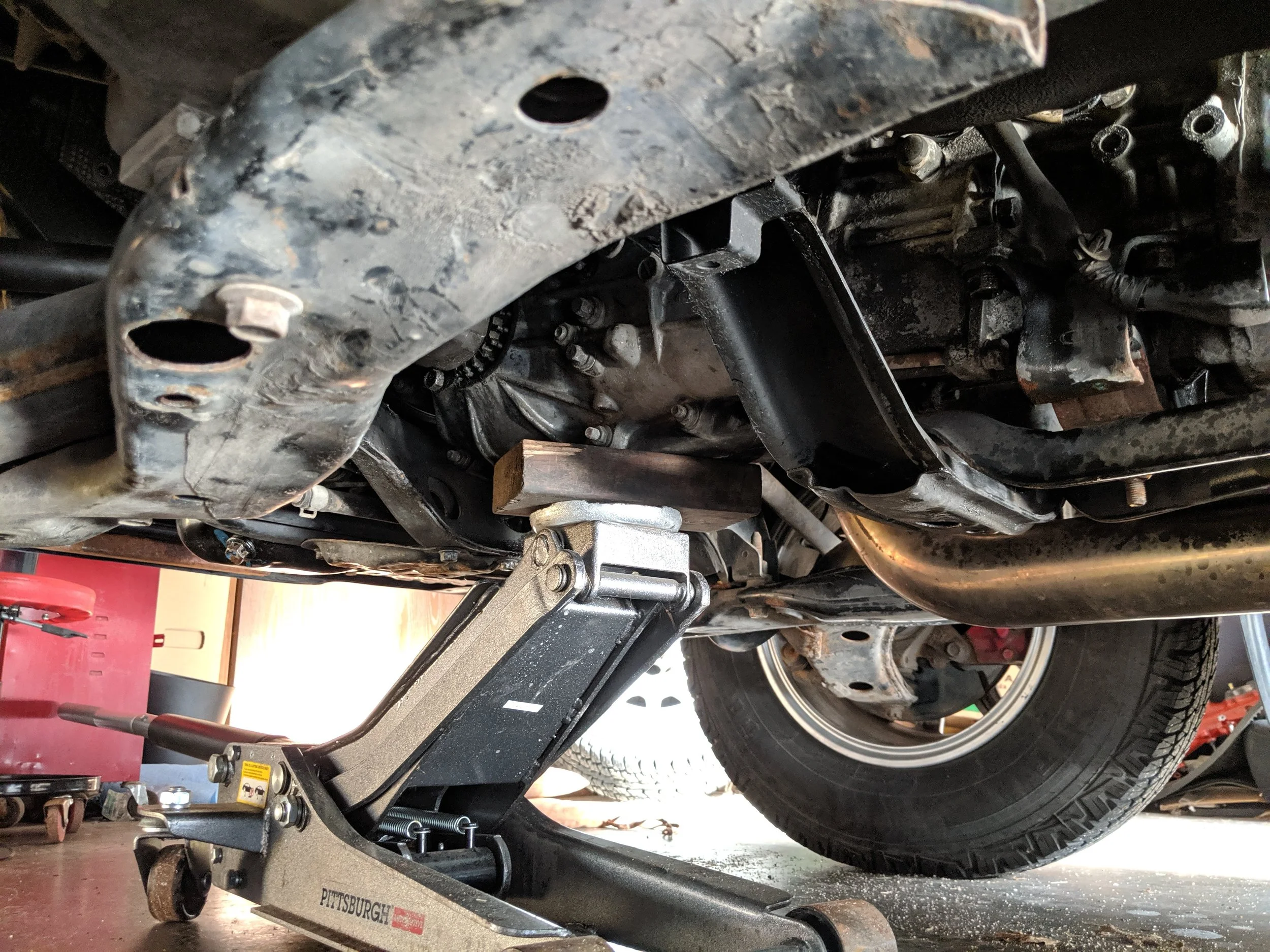 Up and away! You just need to release the weight off the trans to mount, this will help the bolts and nuts to come out without any issues.
