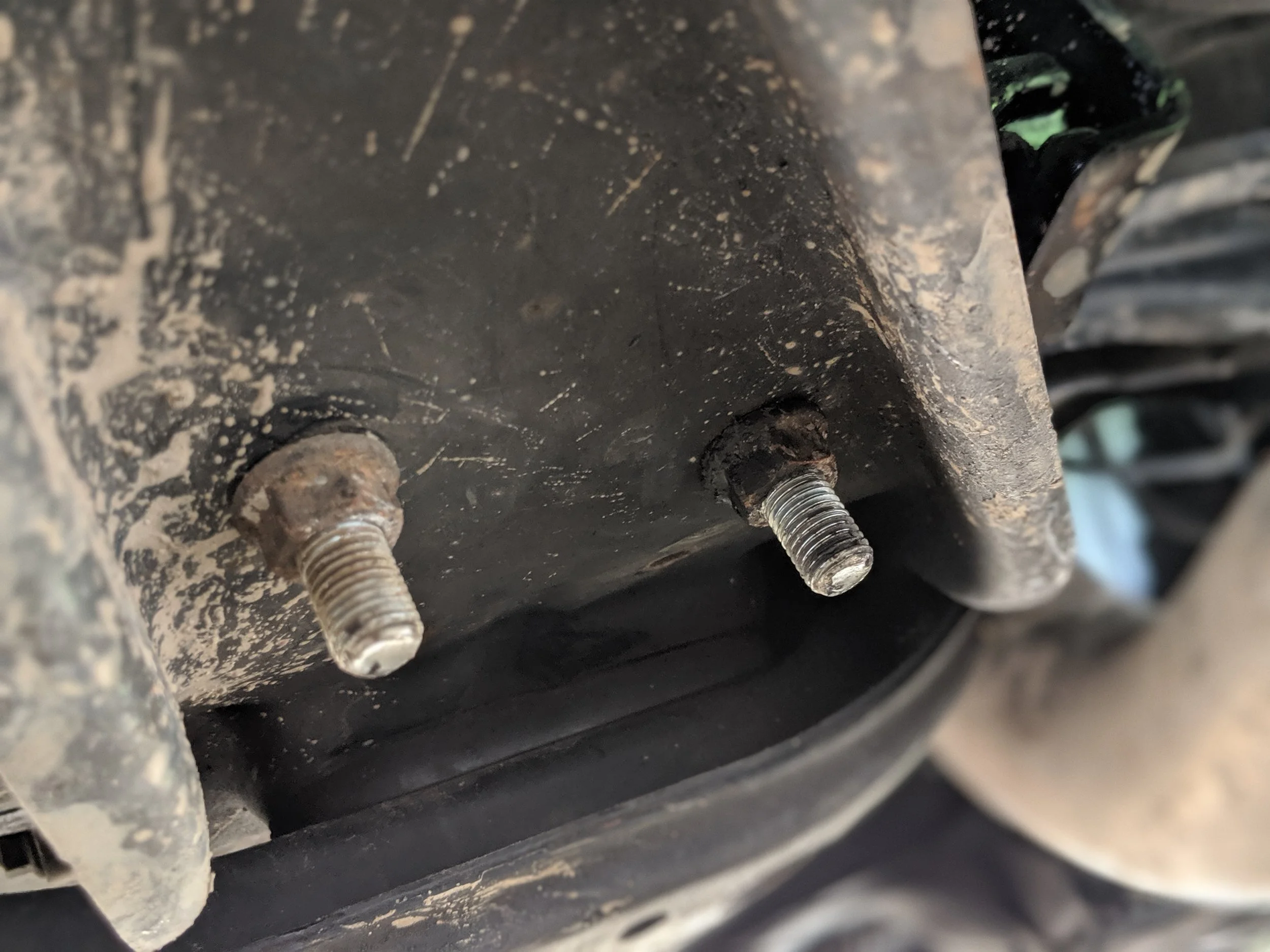 These two nuts hold the transmission mount to the bracing. With them removed the brace will slide on down.