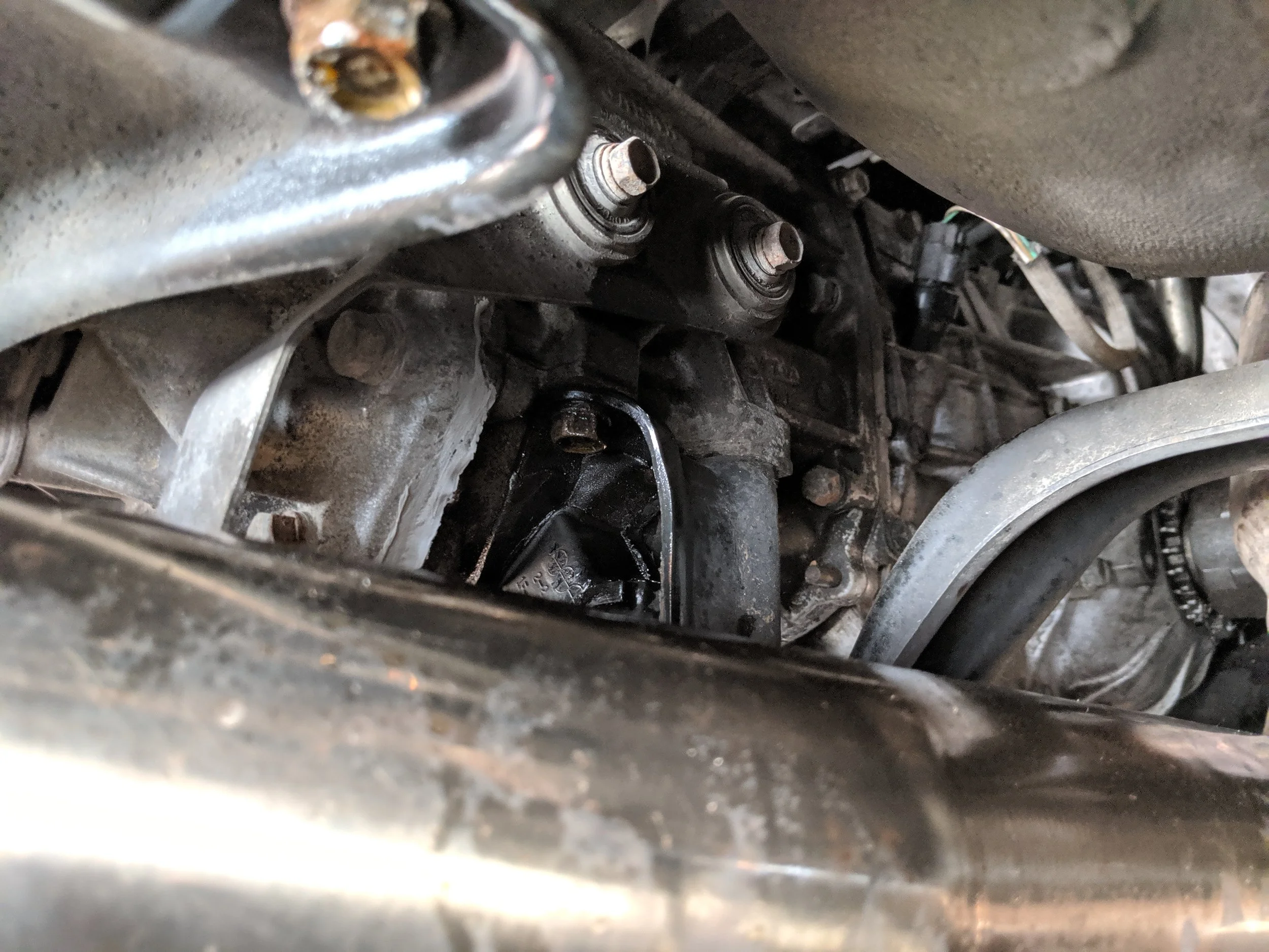 One bolt on the passenger side is visible here. The straight in front of it, just behind the mount in this image.