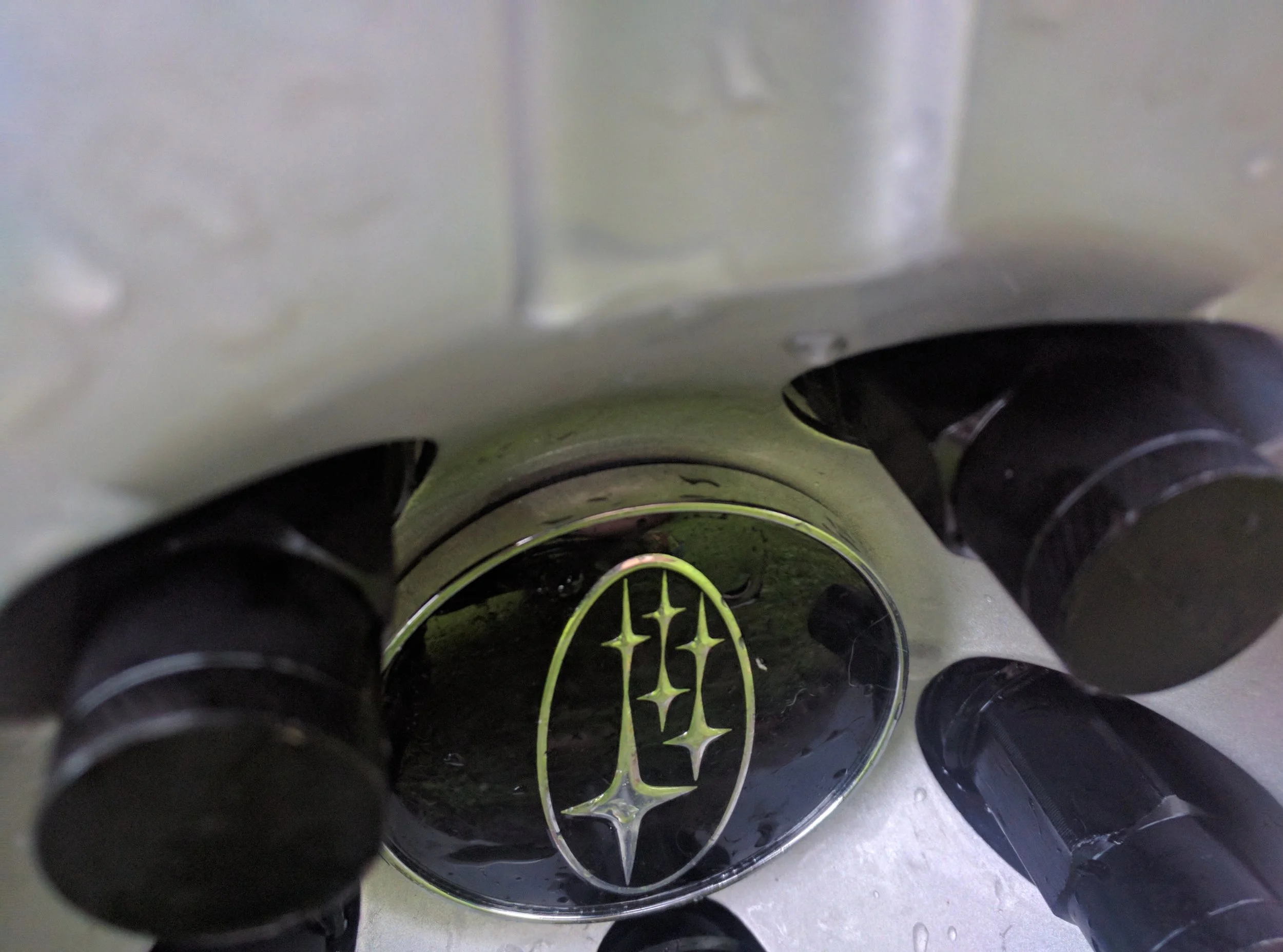 This is the cap pushed down. The clips are a bit taller than the wheel and thus they don’t sit flush.
