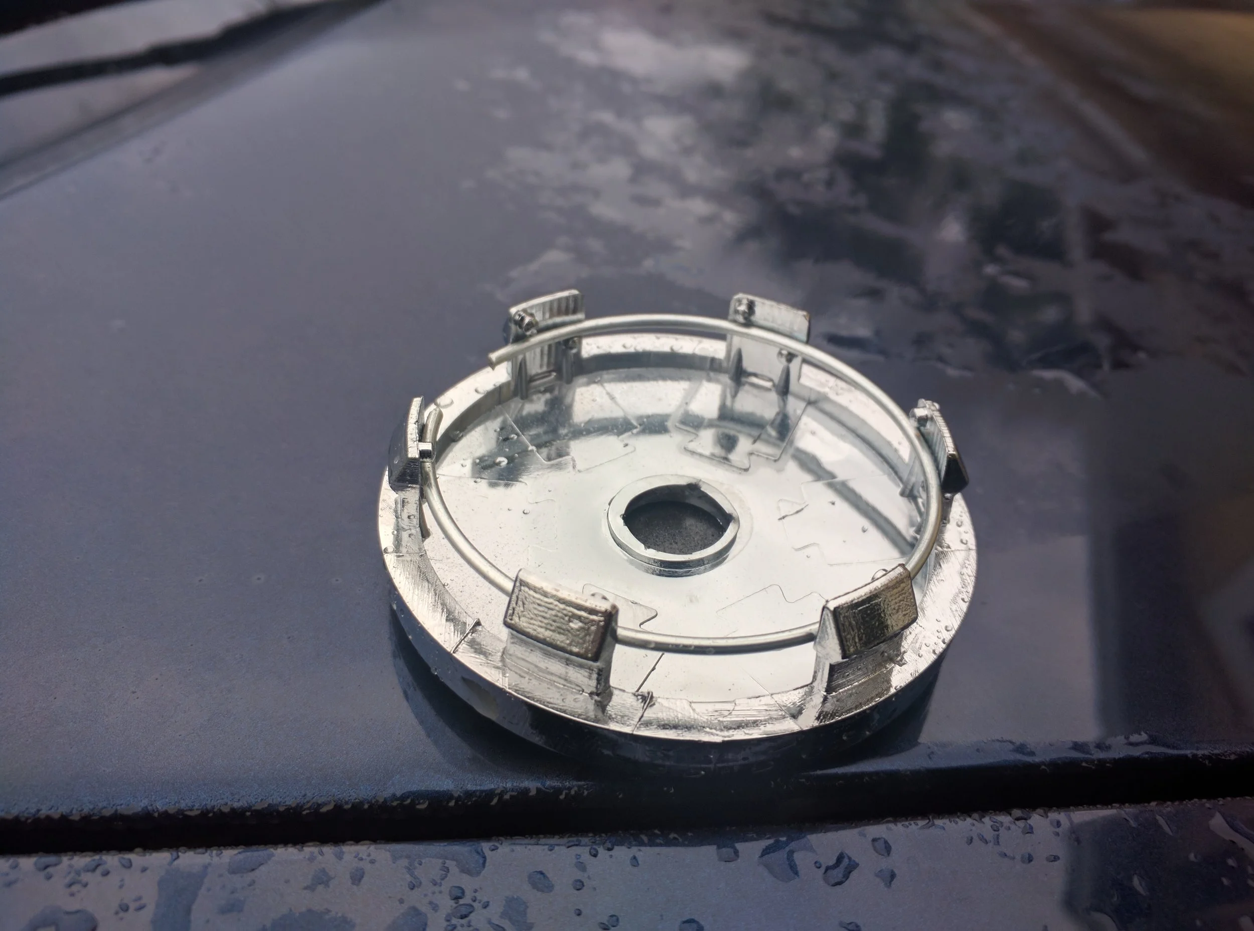 You could easily sand the clips down here to help to sit more flush with the wheel.