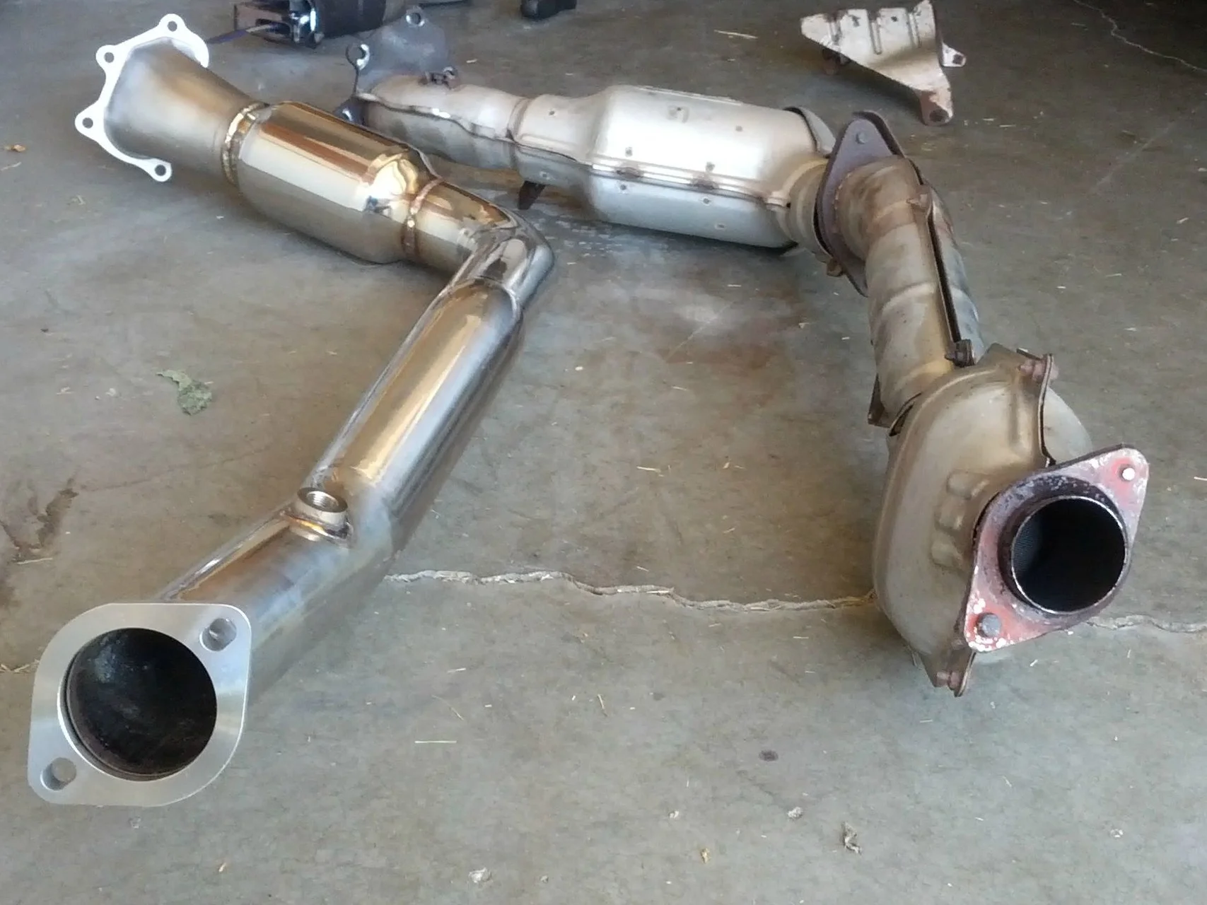 Aftermarket downpipe connection on the left and factory on the right. You can see just how different of a connection they are.