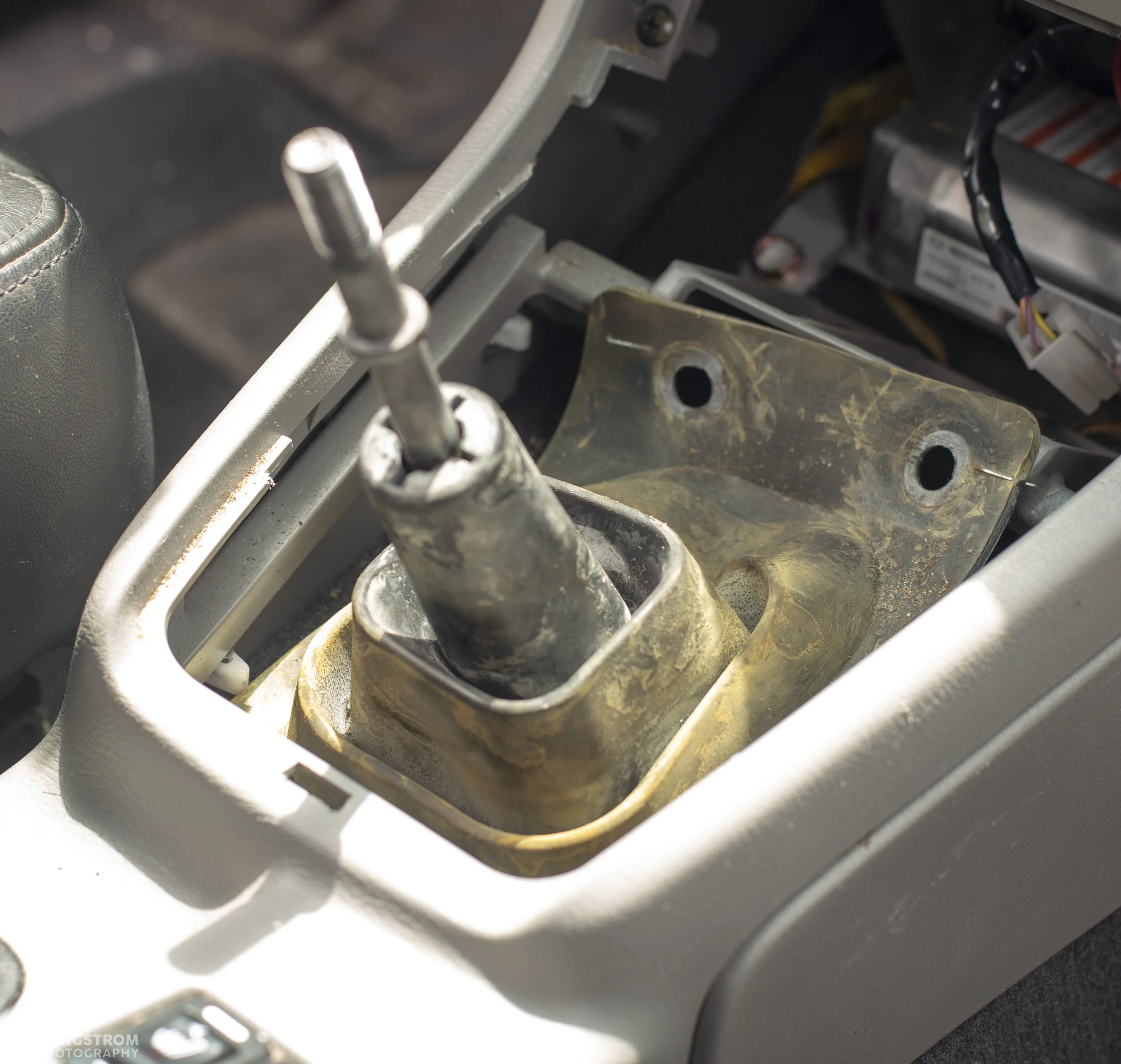 Clips out of the way and you can pull the rubber boot back.