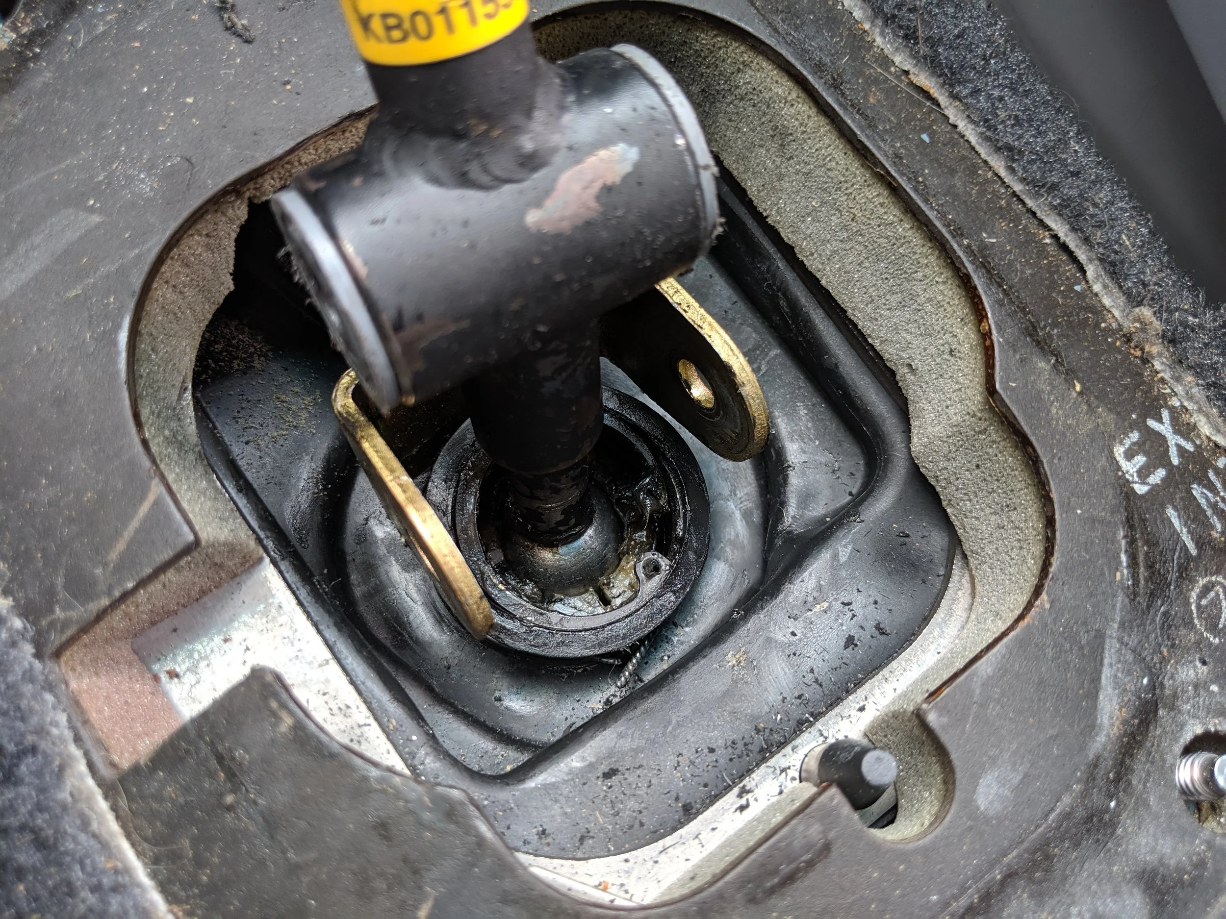Popping the shift lever and cushion back into the linkage. Ready your snap ring pliers to reinstall the c-clip.
