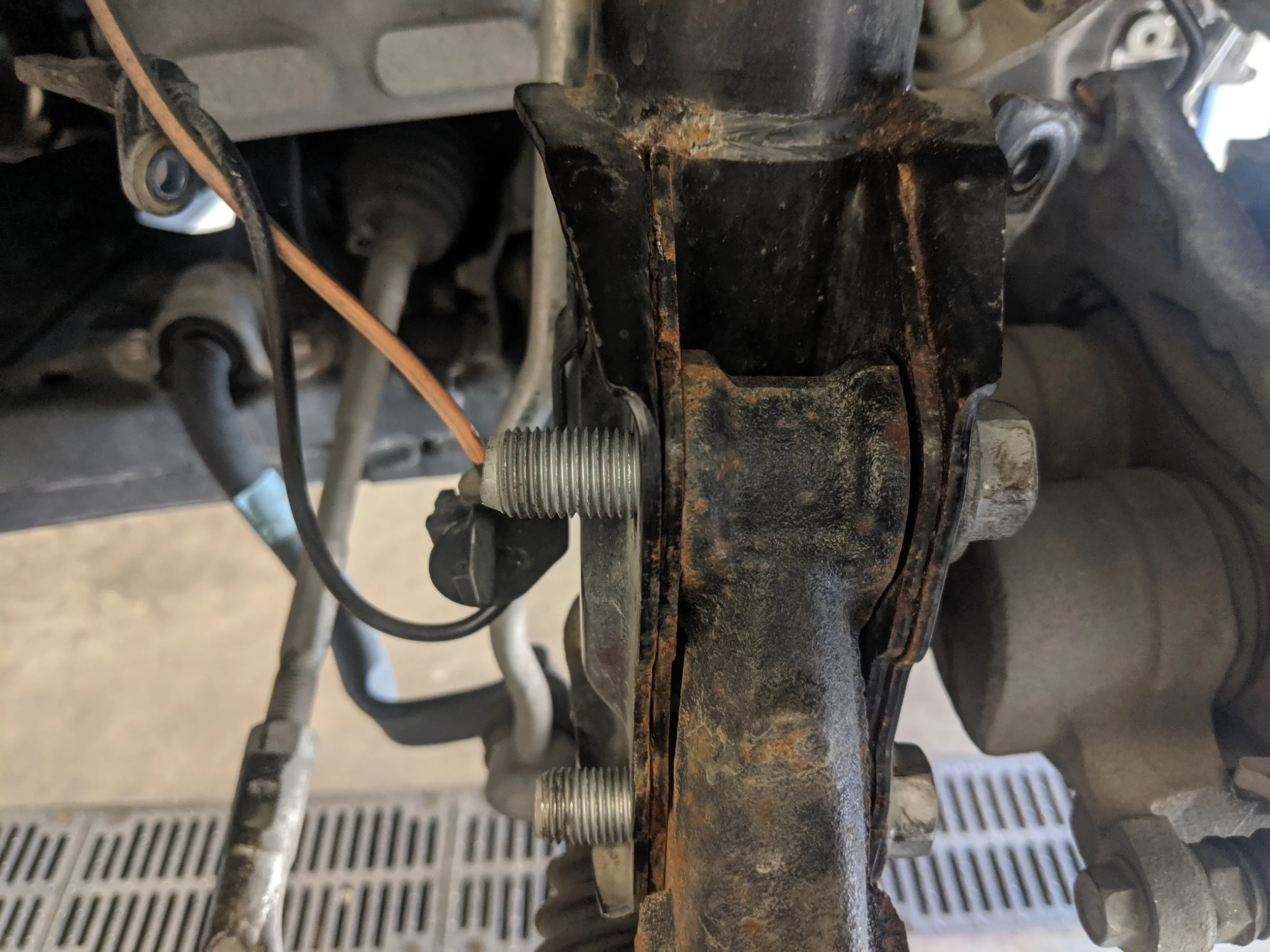 Bolts back in, now install the nuts and run them down. Keeping your camber bolt lined up as your marked it.