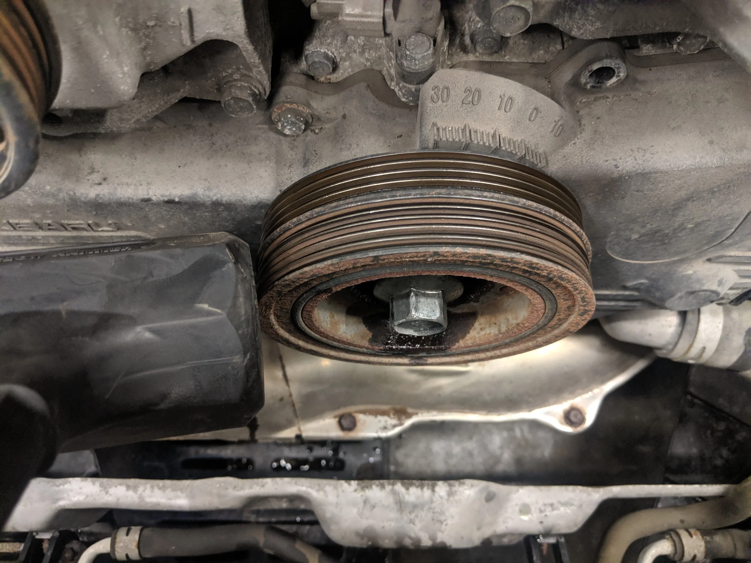 With the pulley bolt hand threaded on, tap the crank pulley to loosen it off crank snout.