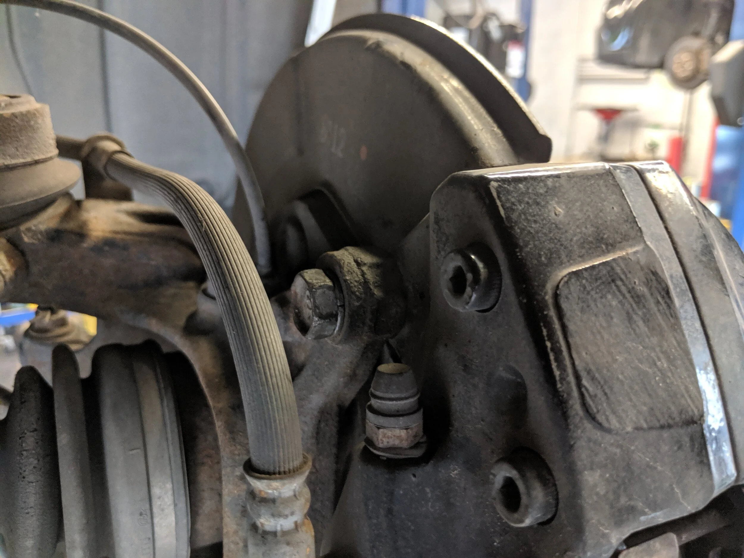 Here is the upper caliper bolt.