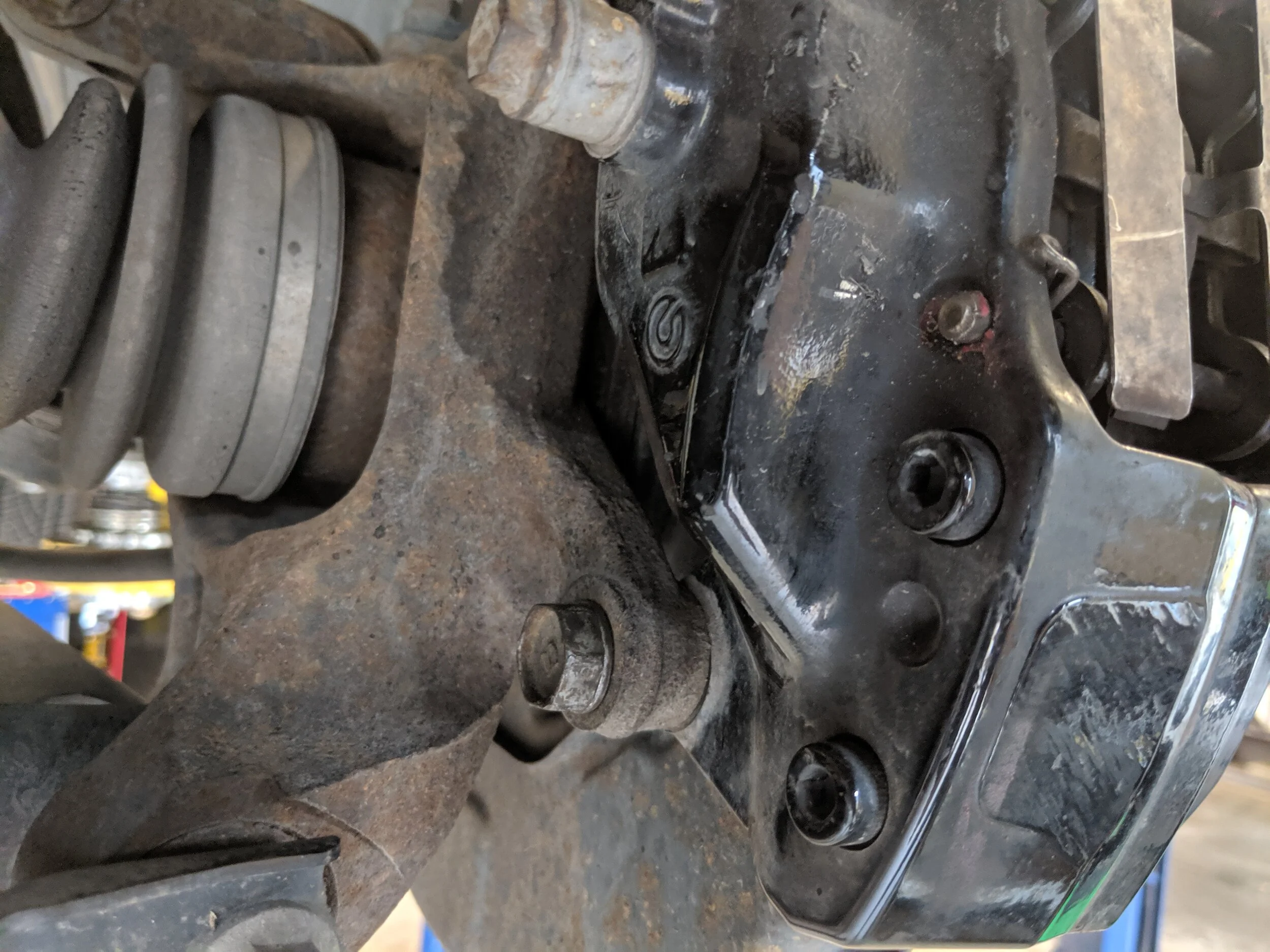 And here is the lower bolt, with both of these removed you will be able to move the caliper to the side.