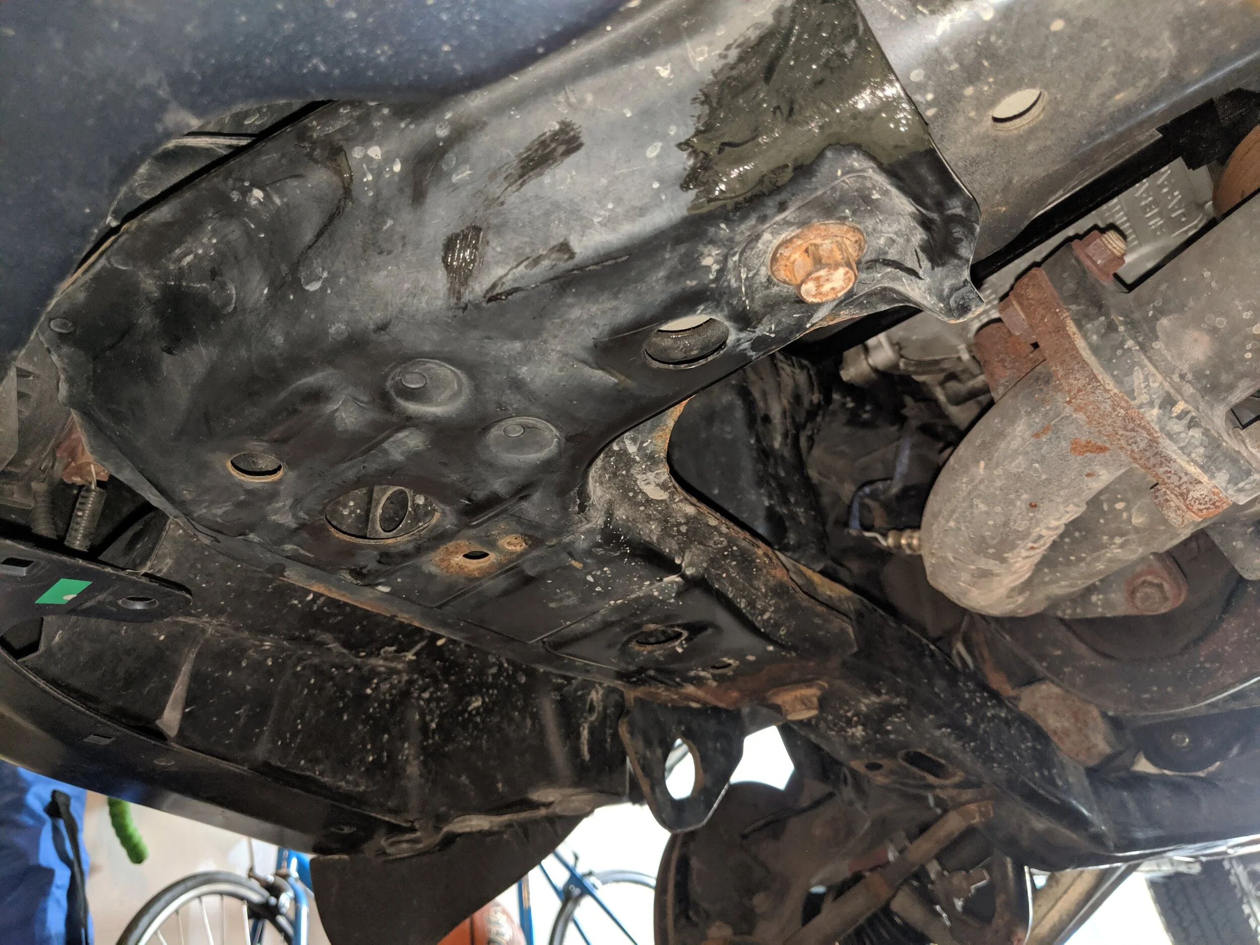 This is your lower subframe just to the left of the exhaust manifold. It stretches from the radiator support to just behind the transverse mount. It is held in place by seven bolts.
