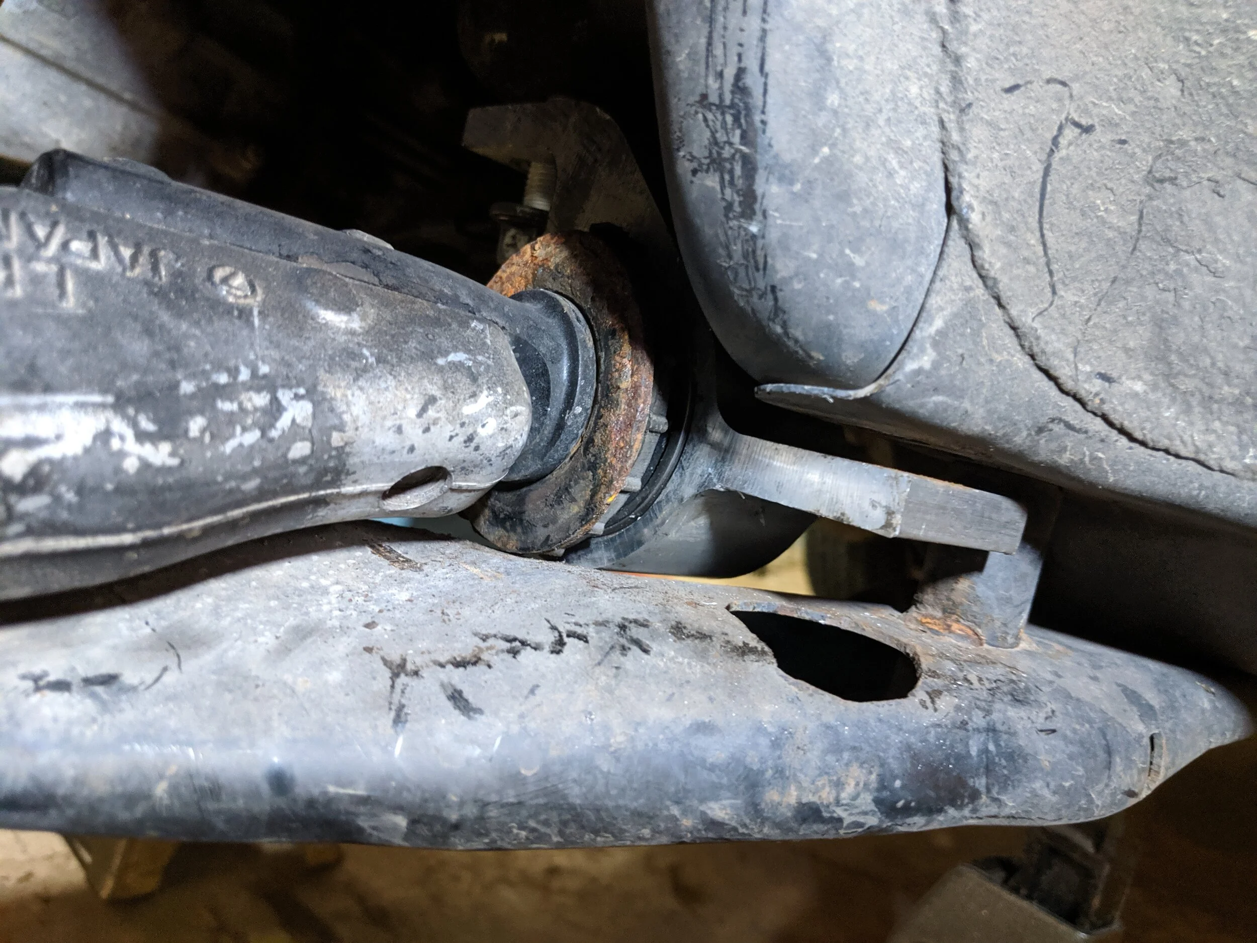 If you leave the subframe on this is what you will need to do. One bolt removed and one very loose to allow the mount to be shifted and allow for the arm to come out.