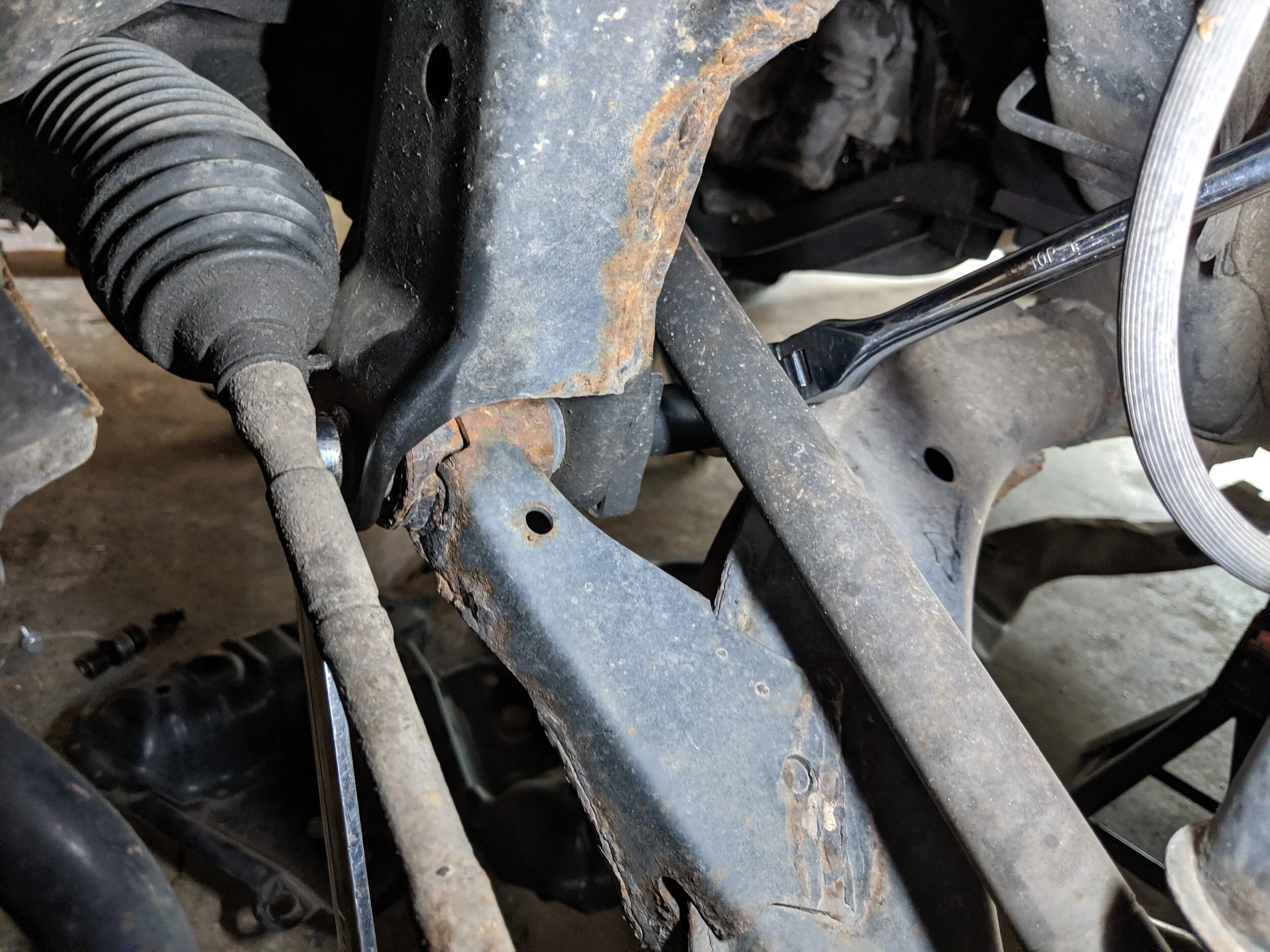 The front control mount is in quite tight quarters. It takes some maneuvering to get your tools on the nut and bolt, then a good amount of strength to break it free.