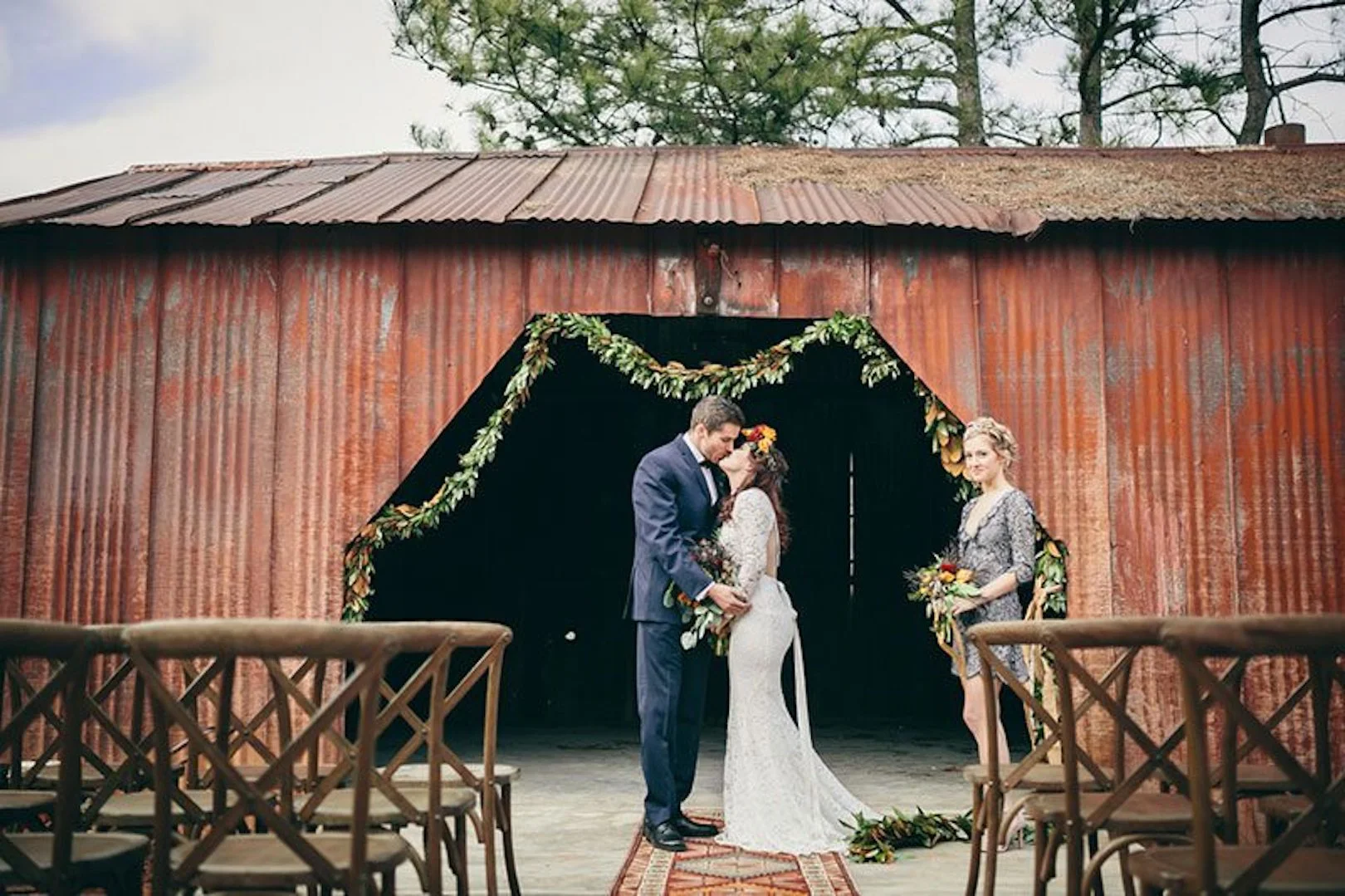 Industrial_Warehouse_Shoot-bride_and_groom_kissing_by_red_building.jpg