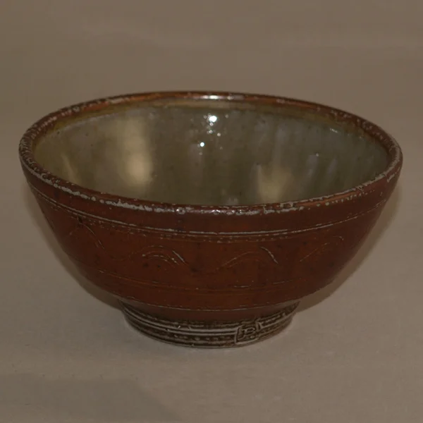 The perfect bowl for your breakfast cereal or soup. Lifted on a turned foot ring this is decorated with an incised wave pattern. The larger size would take a full meal (“The Buddha Bowl”).