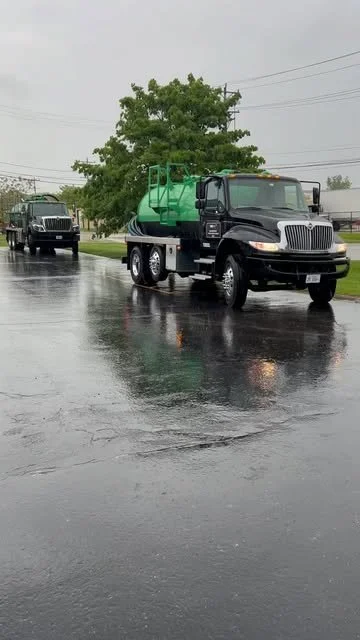 TankServ360 green vacuum tanker truck at an industrial facility