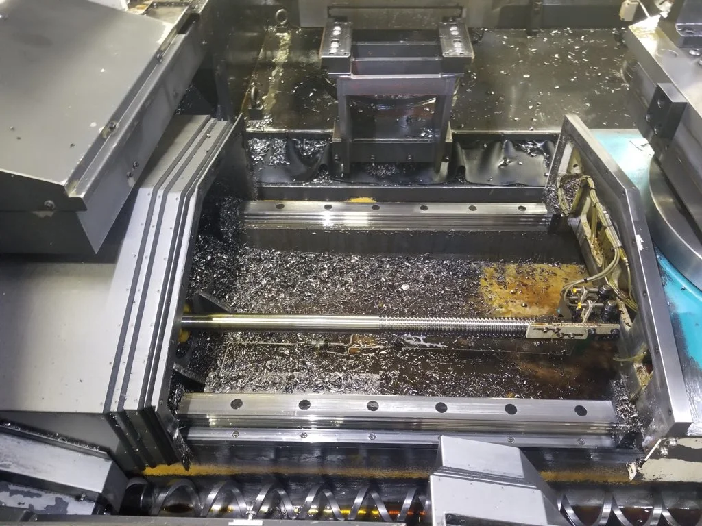 CNC machine with accumulated chips before TankServ360 industrial cleaning