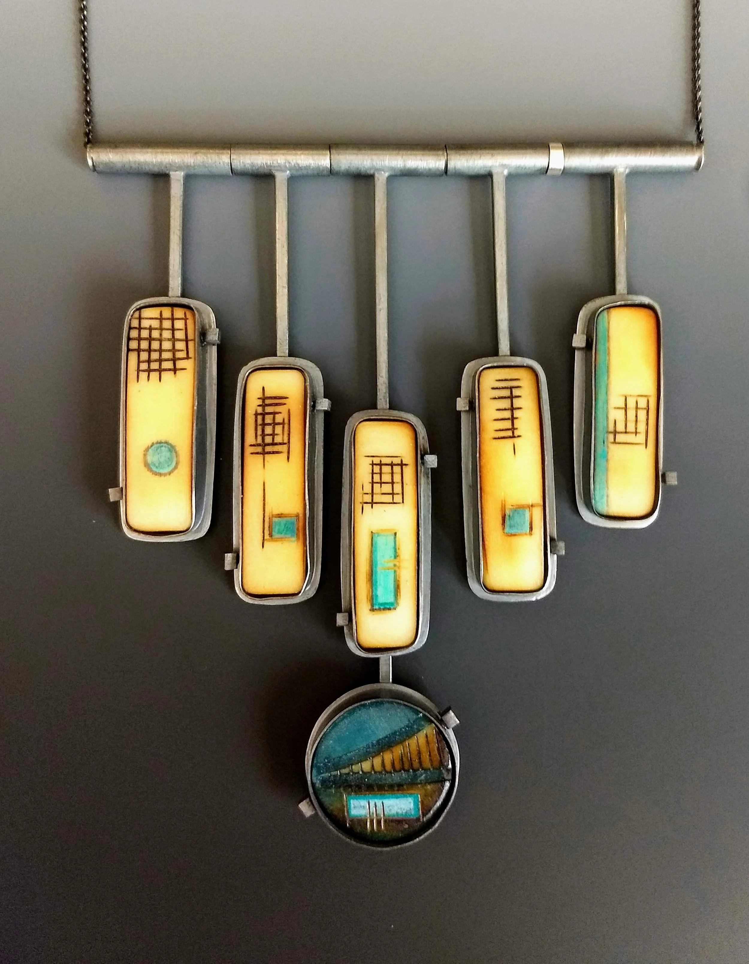 Tagua Pendant, 6 piece, set in oxidized sterling silver. 3.75” x 4.25”. Please inquire about price and availability.