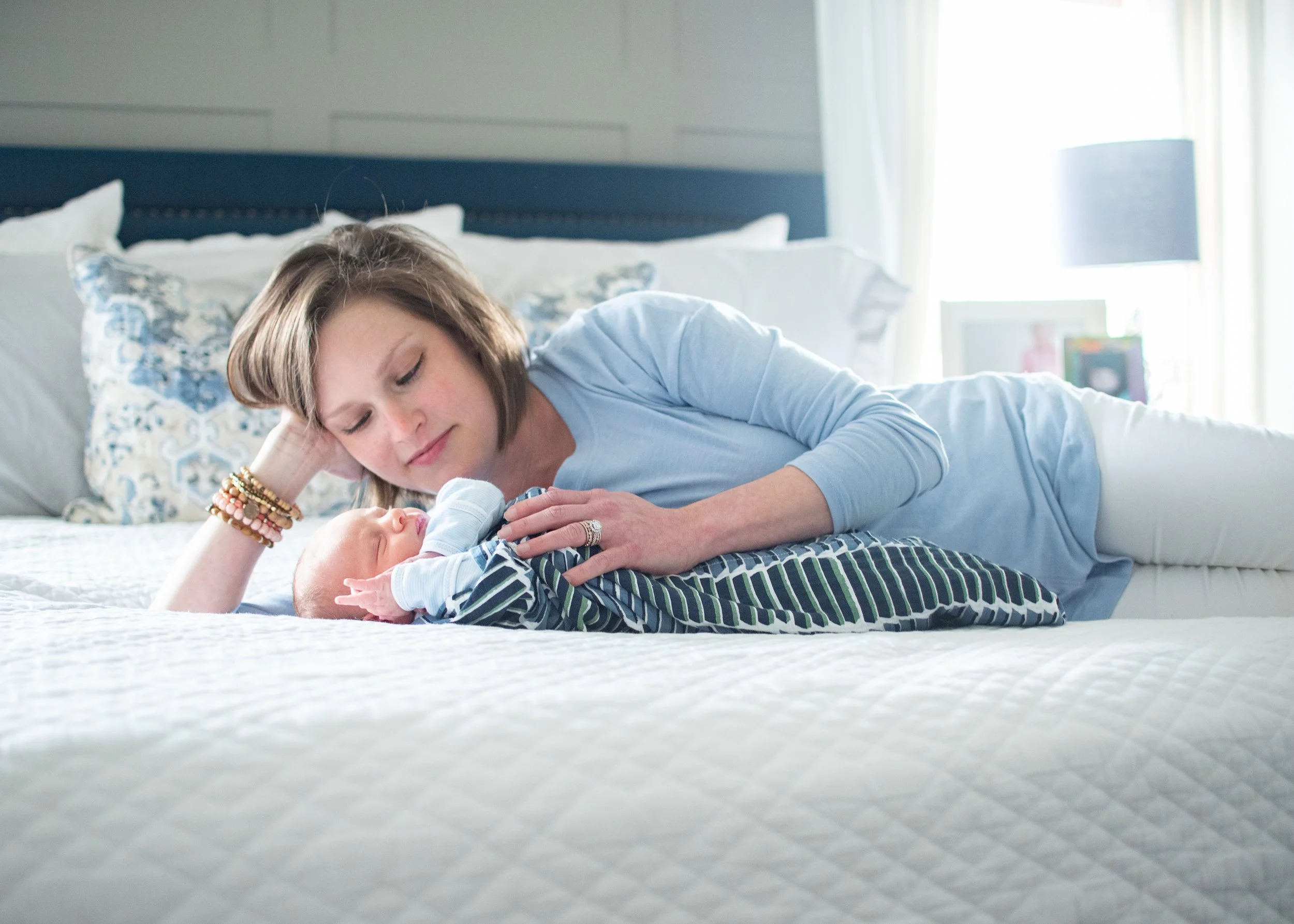mom cuddling with her newborn baby