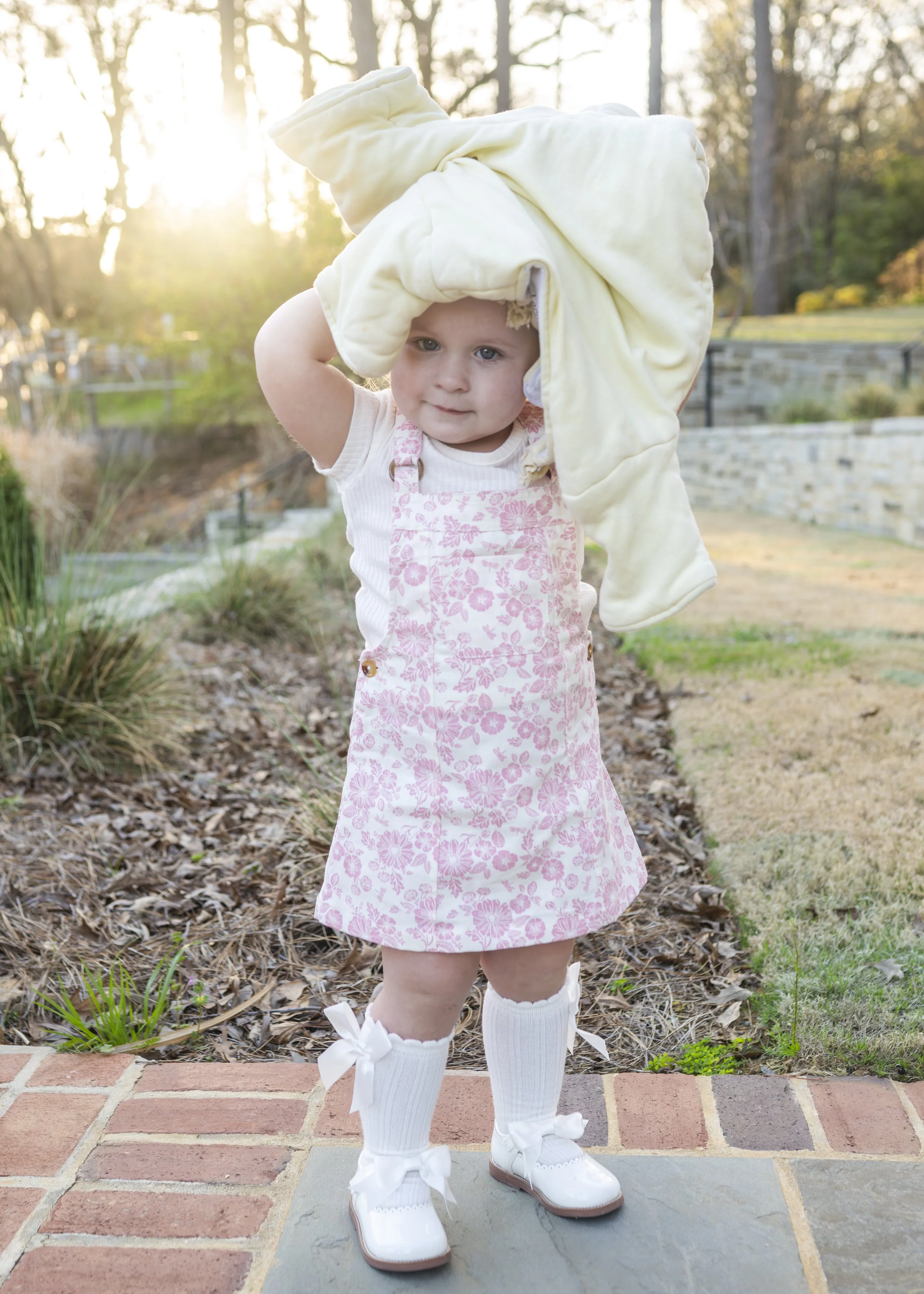  Little girl playing with her lovey at the birmingham botanical gardens 