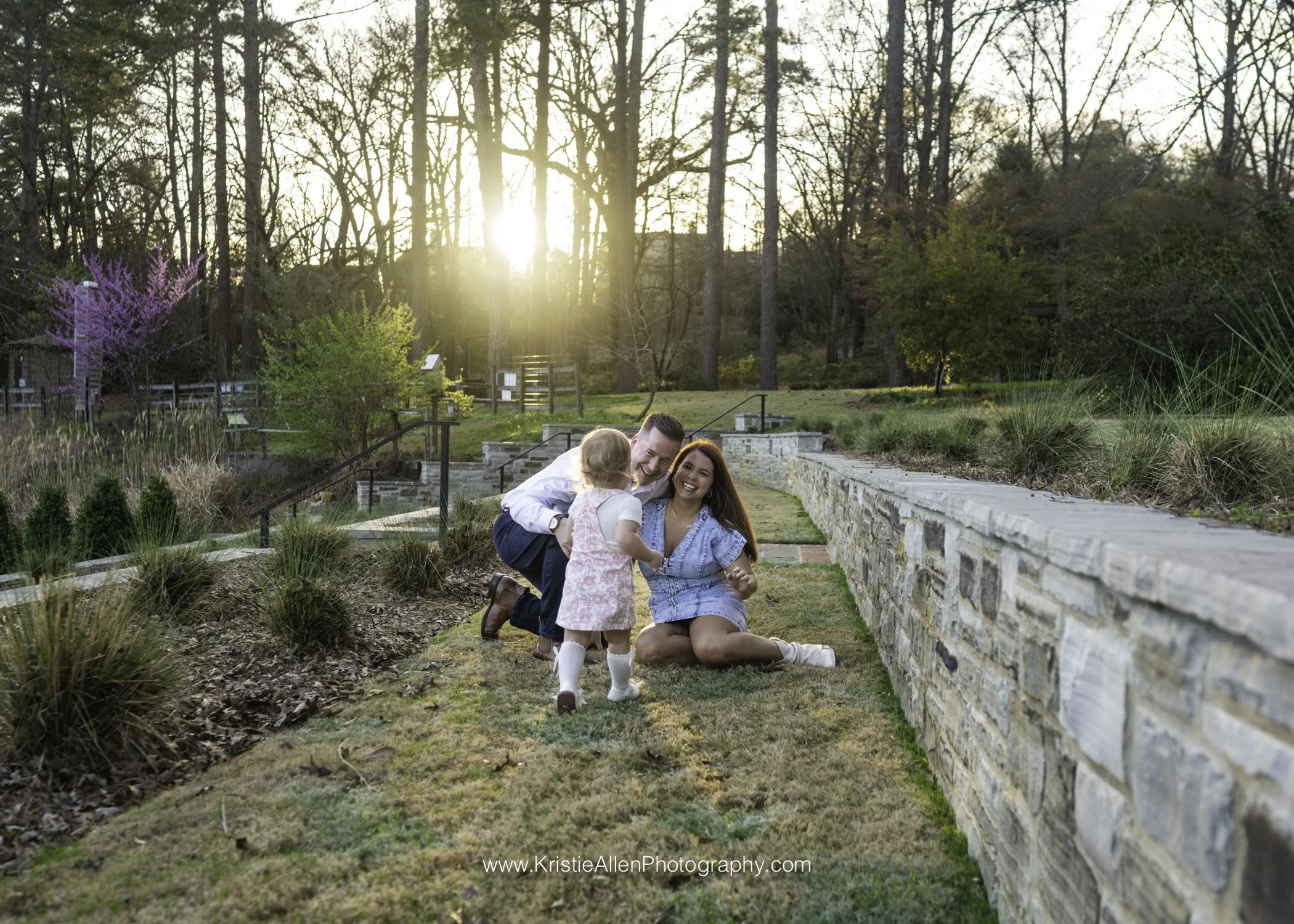 family of 3 at the birmingham botanical gardens, little girl running to parent, Homewood family Photographer