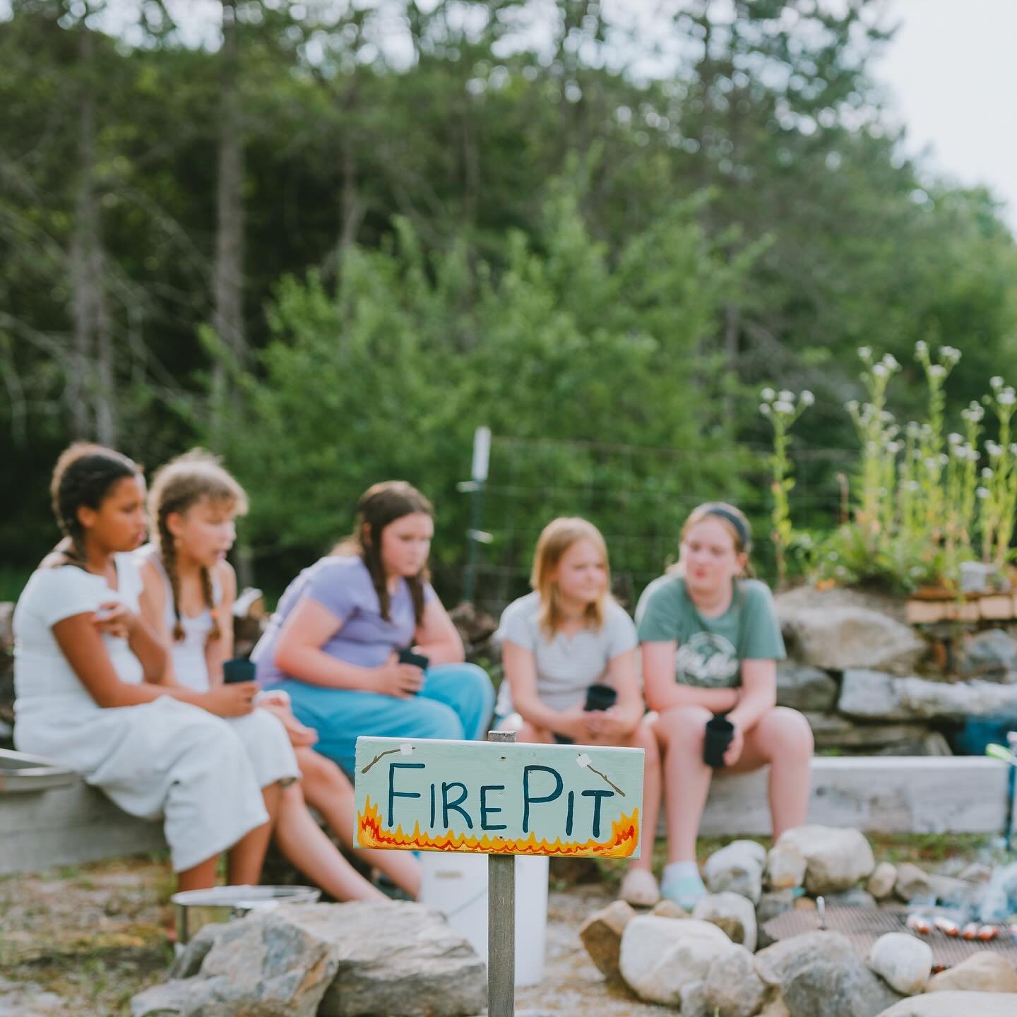 Summer evenings by the fire pit 🔥 some of our favorite parts about cookouts at camp &mdash; roasting sweet corn in it&rsquo;s husk over the fire, endless fresh watermelon, s&rsquo;mores (obviously!), and all the games and stories that come as the su
