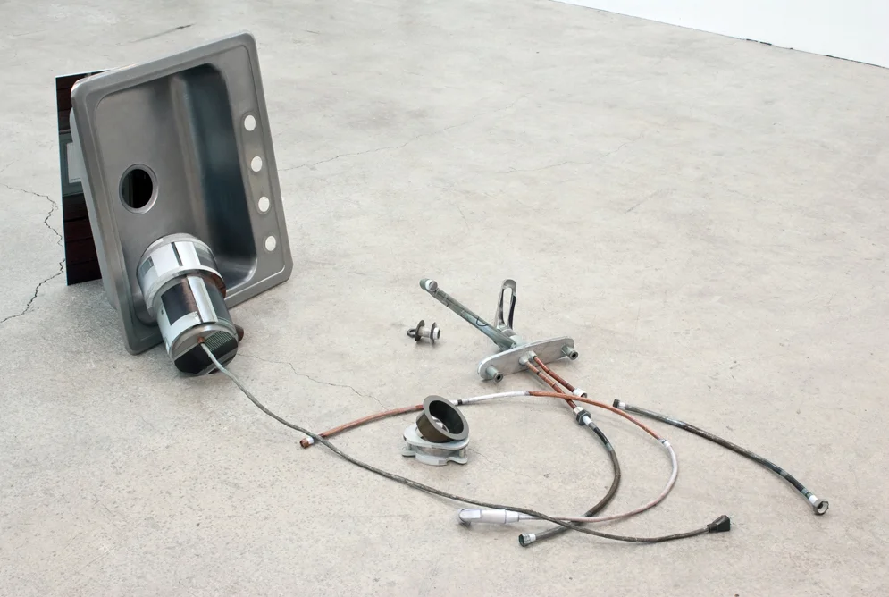 Recinere (Faucet/Disposal), 22” x 52” x 35”, pigment prints mounted on aluminum, stainless steel sink, wood, paper, glue, 2010
