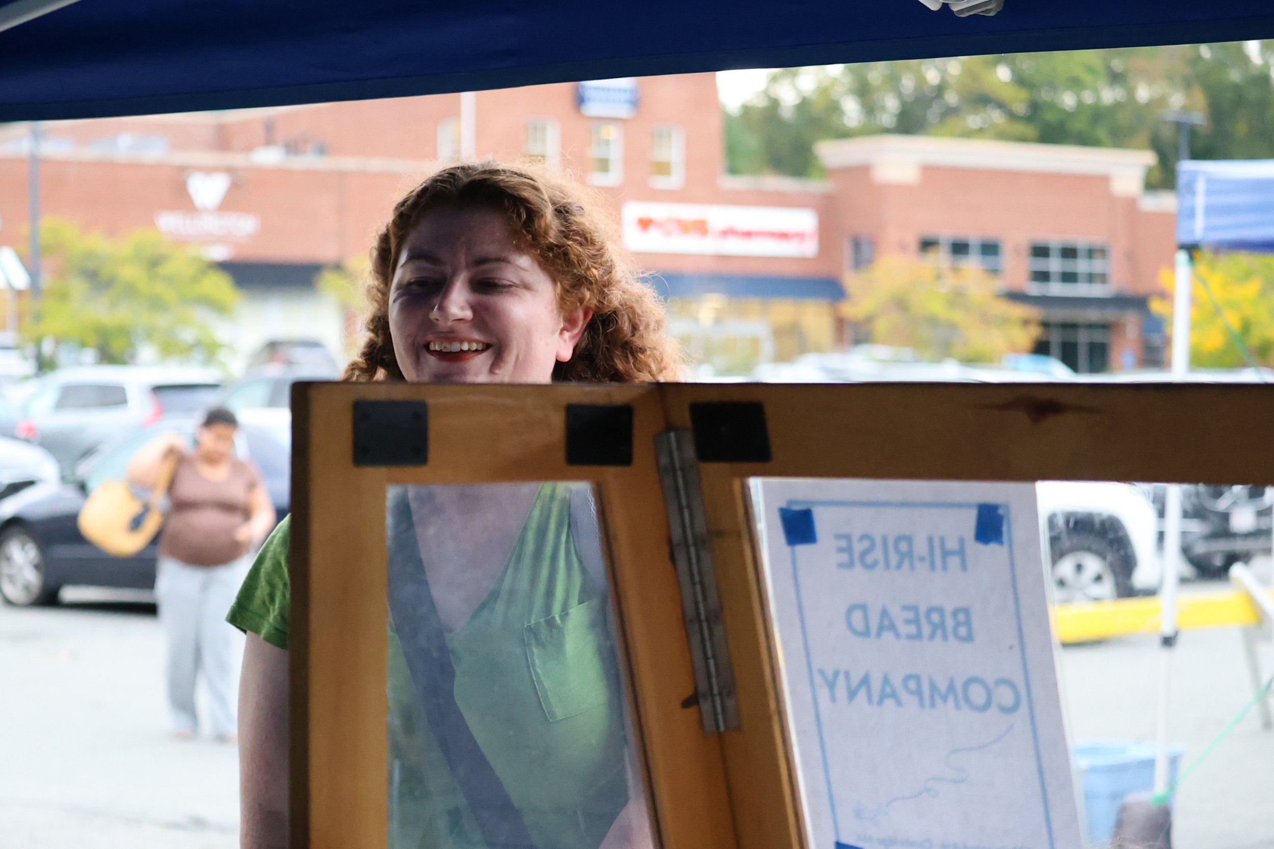 A shopper looking over a glass divider at products