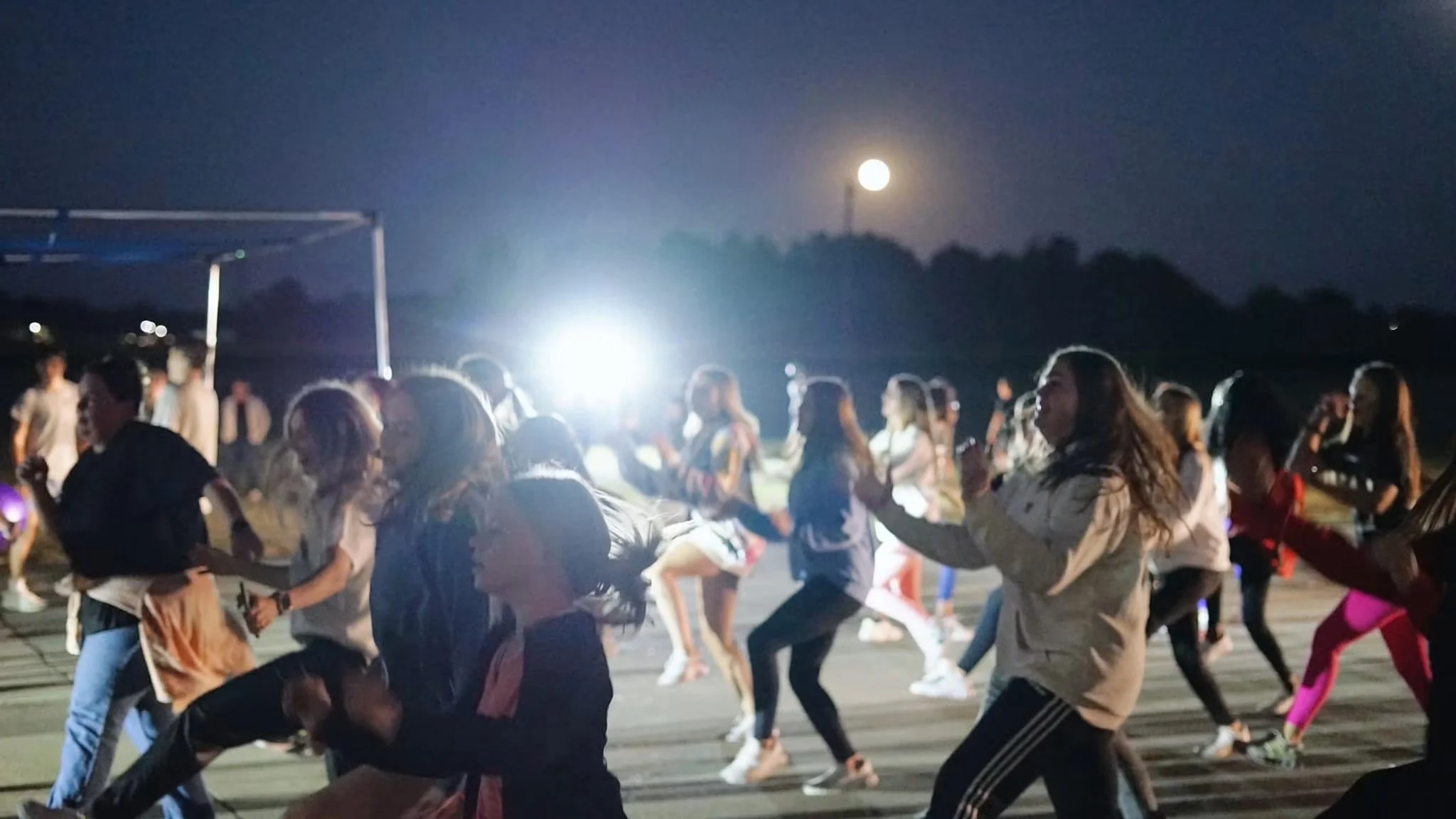 Students dancing and celebrating together outdoors at MOVE NIGHT