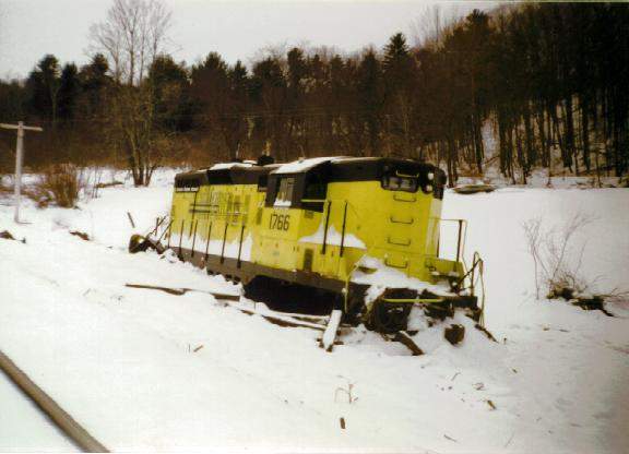 St. Lawrence & Atlantic GP9 on a slight detour St. Lawrence & Atlantic GP9 #1766 decided to take a detour off the tracks on a fridgid winter day in New Gloucester, ME. The cause of the derailment was blamed on ice in a crossing about 50 yards back. Luckily, the train crew walked away with only a few minor bumps. Photographed by Joe Czapiga, February, 1996. Added to the photo archive by Joe Czapiga, January 23, 1998. Railroad: St. Lawrence & Atlantic.