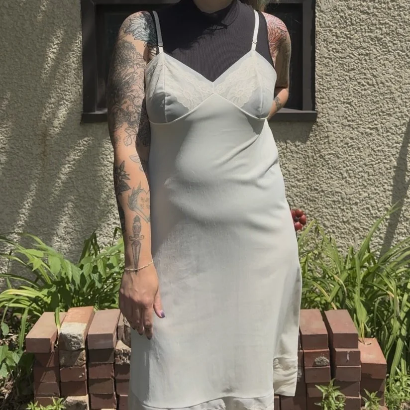 A sheer material slip dress styled with a bodysuit underneath