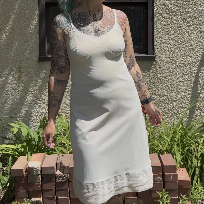 a sheer slip dress styled with a tank top and spandex shorts underneath