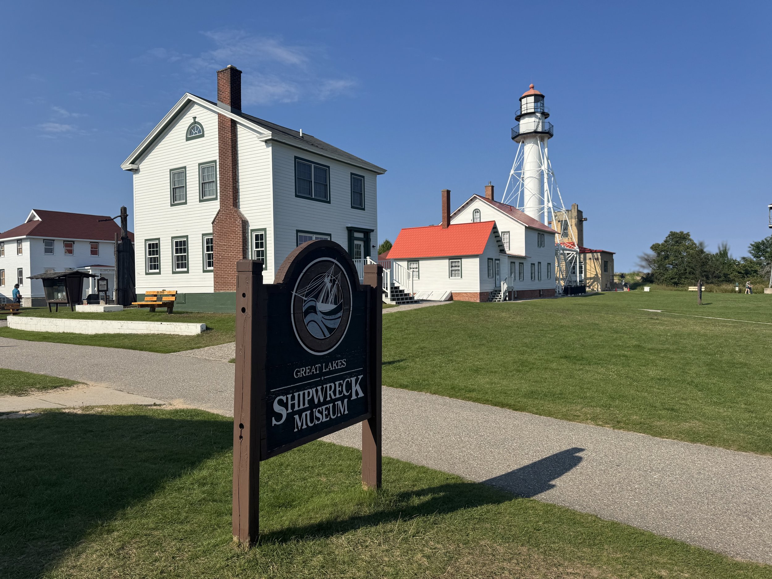 Sign and several buildings that are a part of the Great Lakes Shipwreck Museum