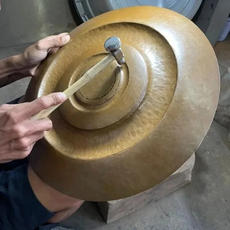 Hand-hammered copper element during fabrication