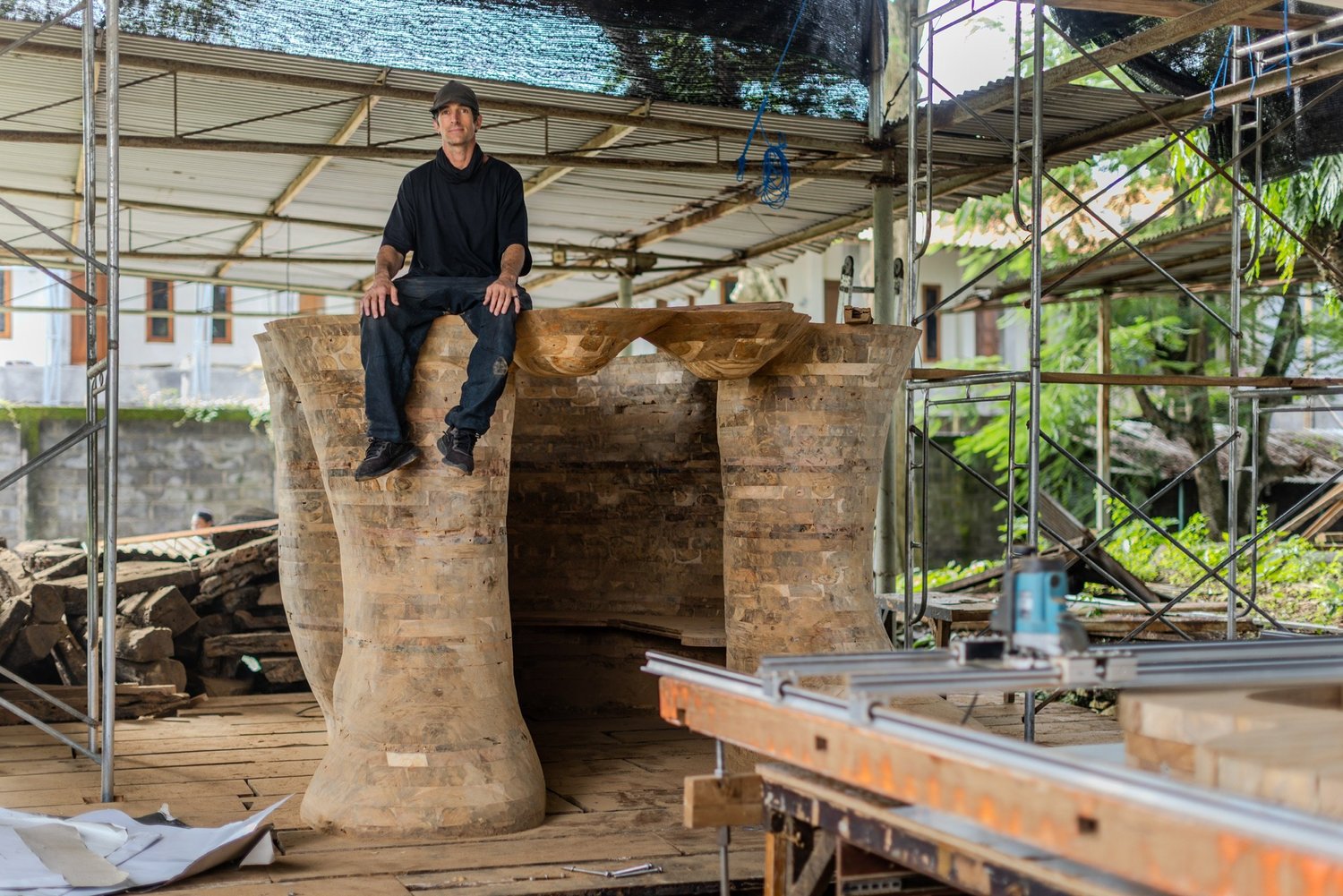 Spencer Hansen seated on the Behind Closed Eyes sculpture during fabrication