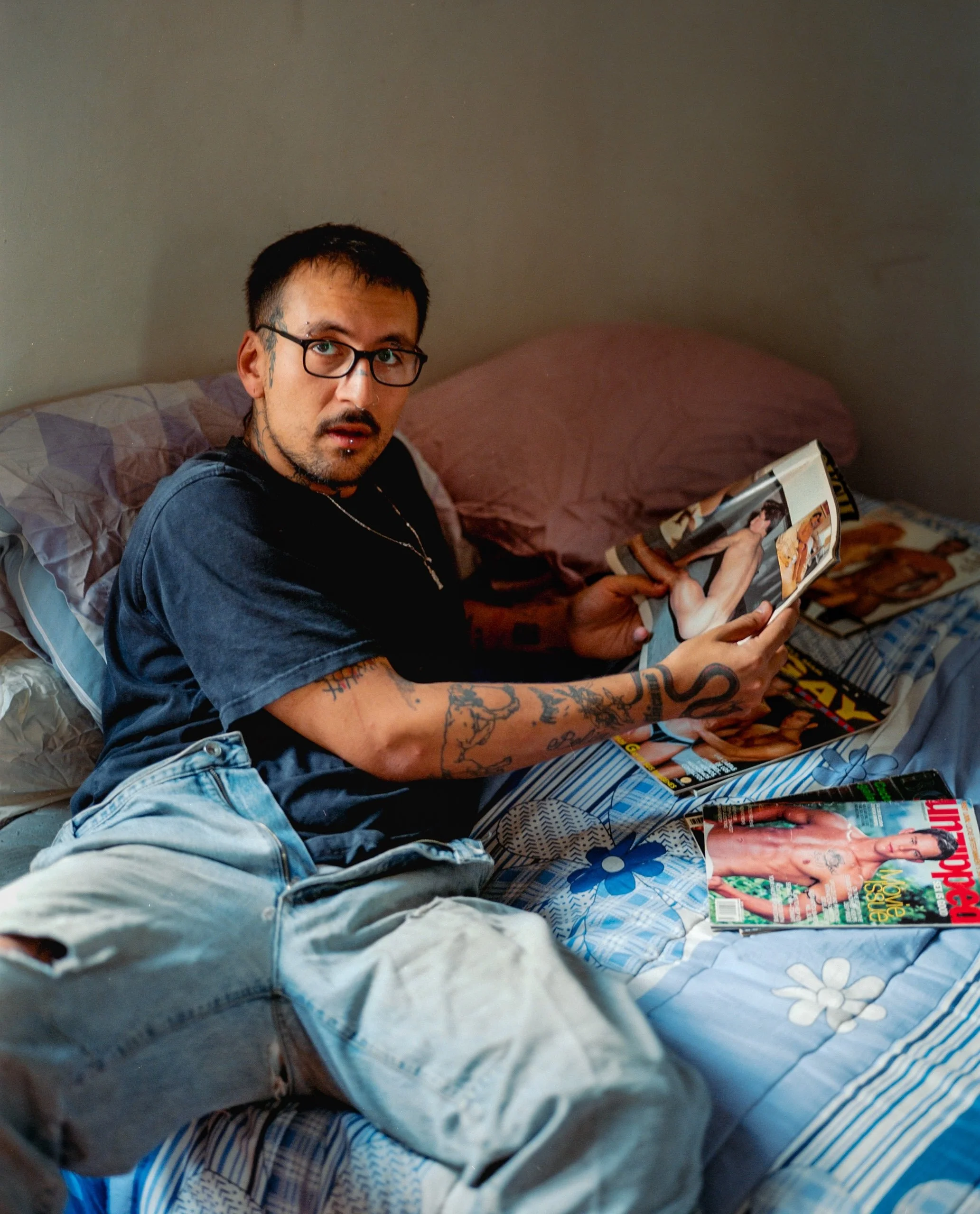 a-caged-dog-barks-the-fiercest-mexico-city-2024-man-seated-on-bed-ryan-otoole-collett.jpeg