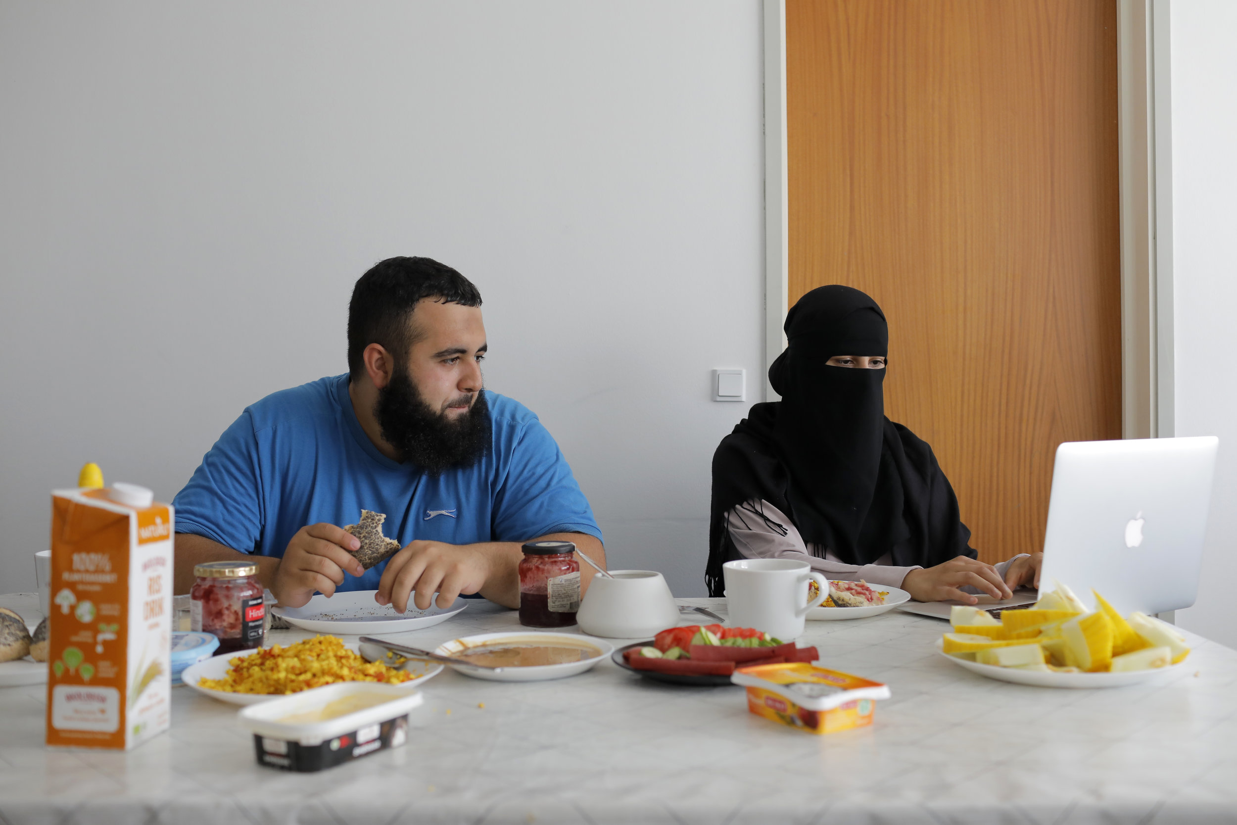  Ali watches on as his wife, Meryem, a 20 year old student of microbiology and medicine, works on her blog over a prepared vegan breakfast in Aarhus. Ali supports Meryem’s decision to wear the niqab but feels life would be easier if she chose not to 