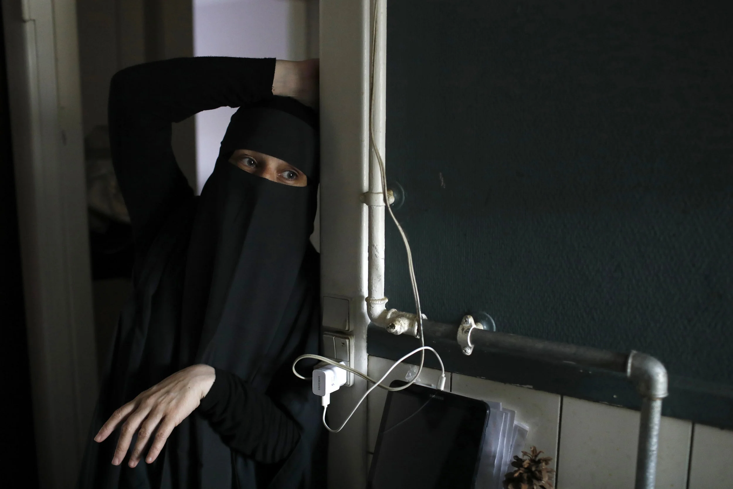  Ayah pauses within the residence of her friend, Ahlam.  