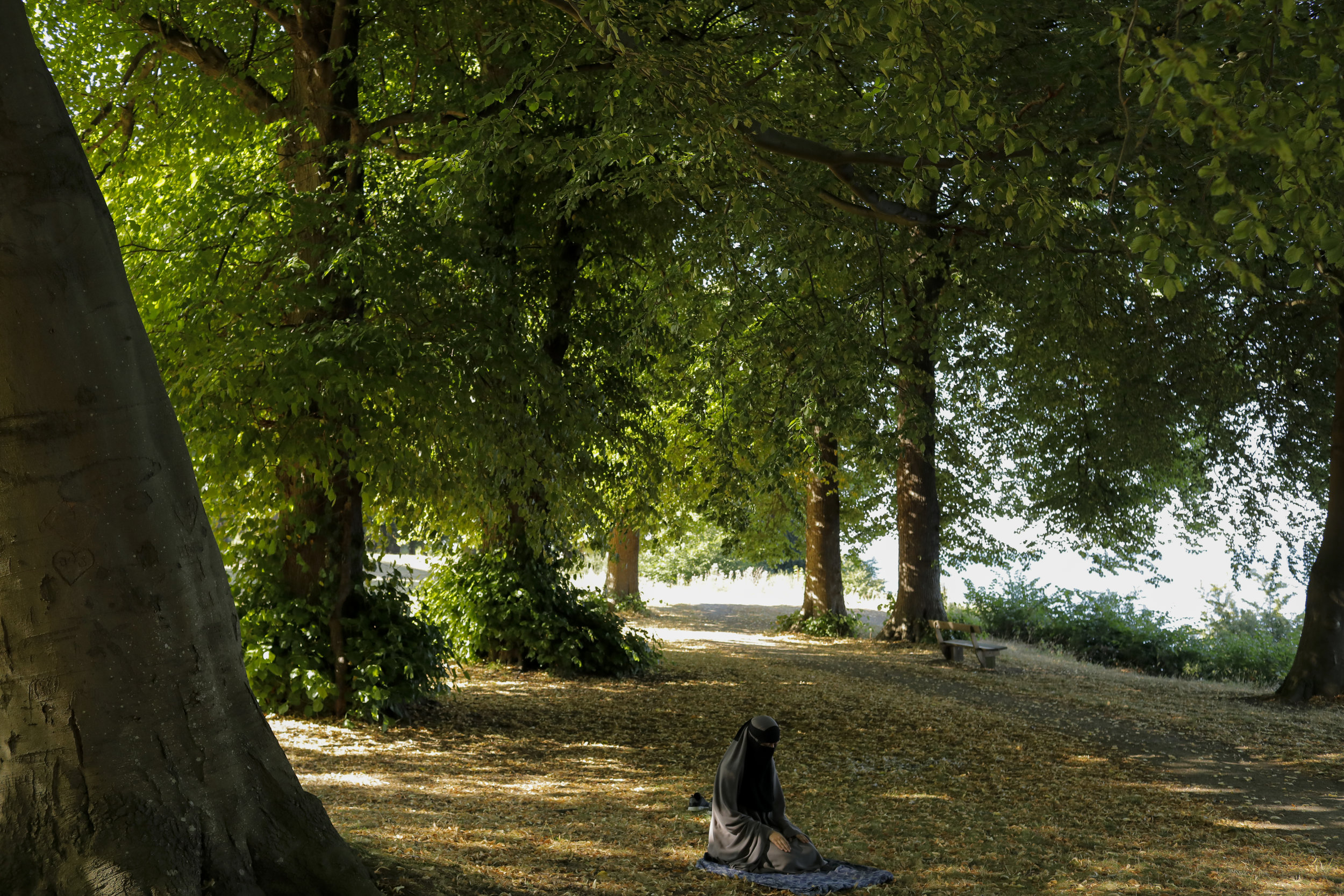  Sabina prays in a park by the seaside. Devoutly religious, her parents constantly worry about her safety over her choice to wear a niqab in the deeply divided country of Denmark.  