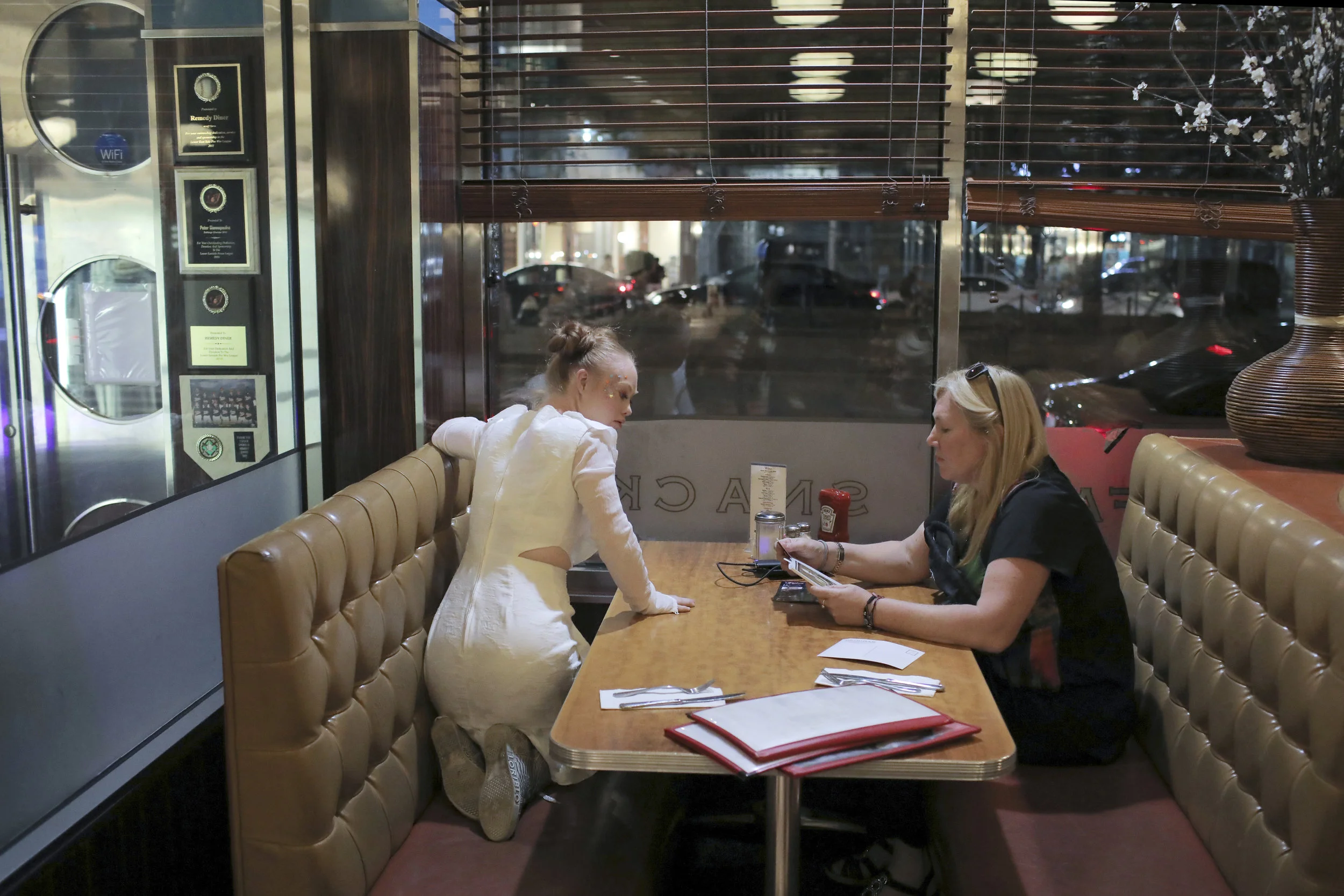  Madeline and Rosanne wait for their dinner at the Remedy Diner in downtown Manhattan. The two frequent the diner most nights due to its 24 hour service. Dinner is eaten once all shows are done, sometimes as late as midnight.  