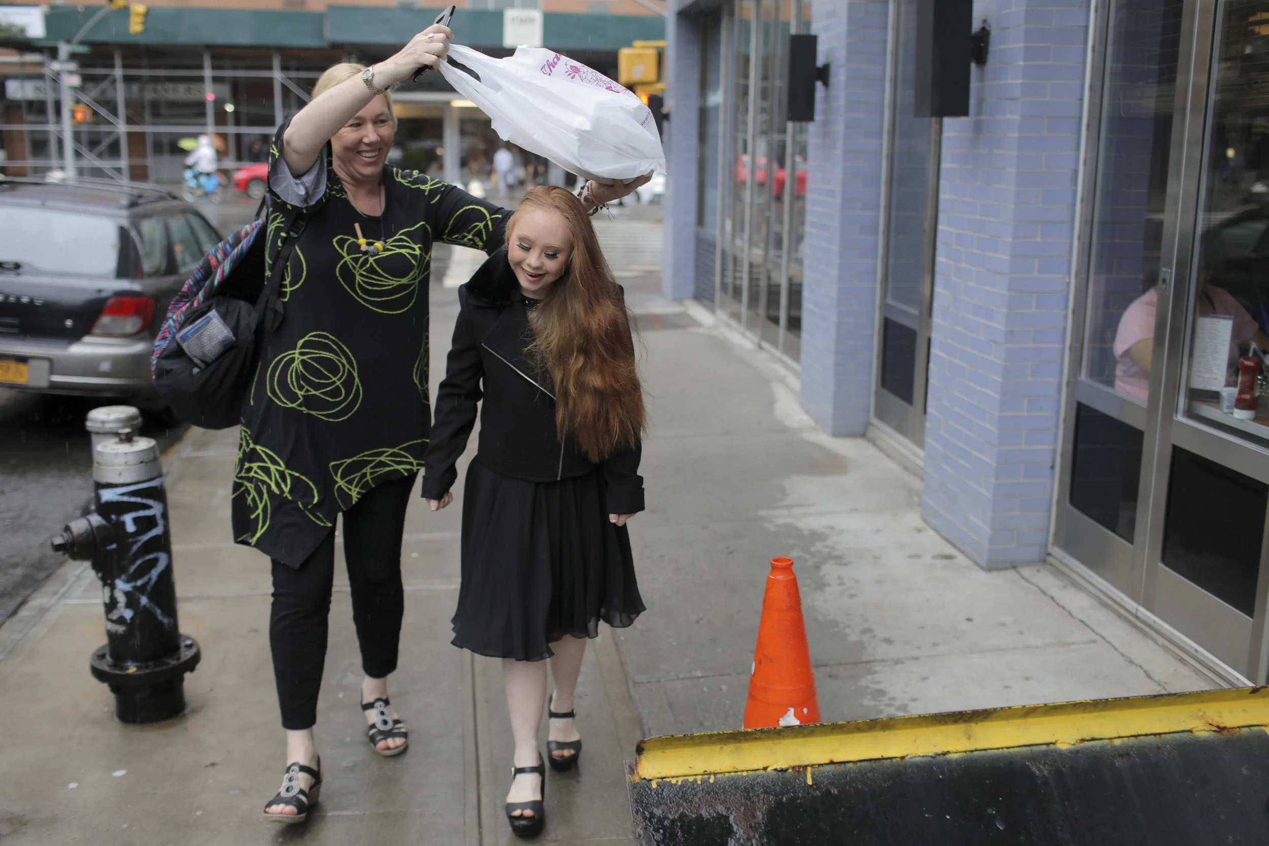  Rosanne shields Madeline from falling rain. Rosanne has been a single mother since Madeline’s birth and the two share an immense bond.  