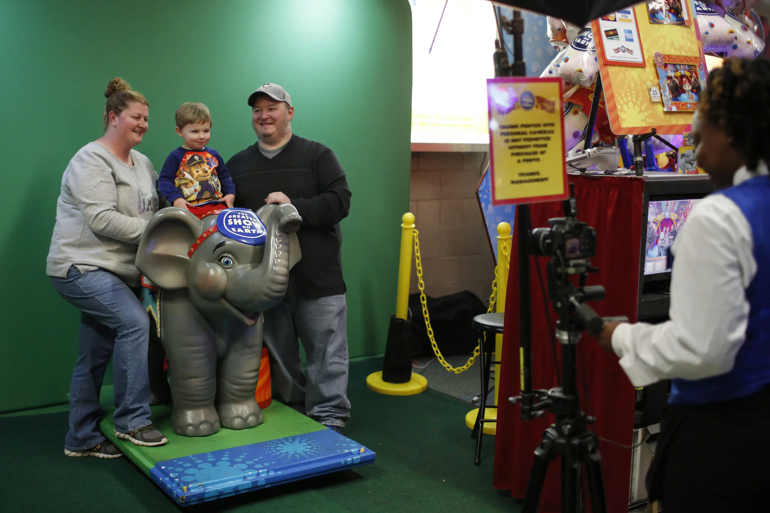 People pose with tier child on an elephant at a photo booth in the concourse of the Ringling Circus. The elephants were something of a mascot for the circus with many people coming out to celebrate their last appearances. Their final performance in Wilkes Barre was sold out.