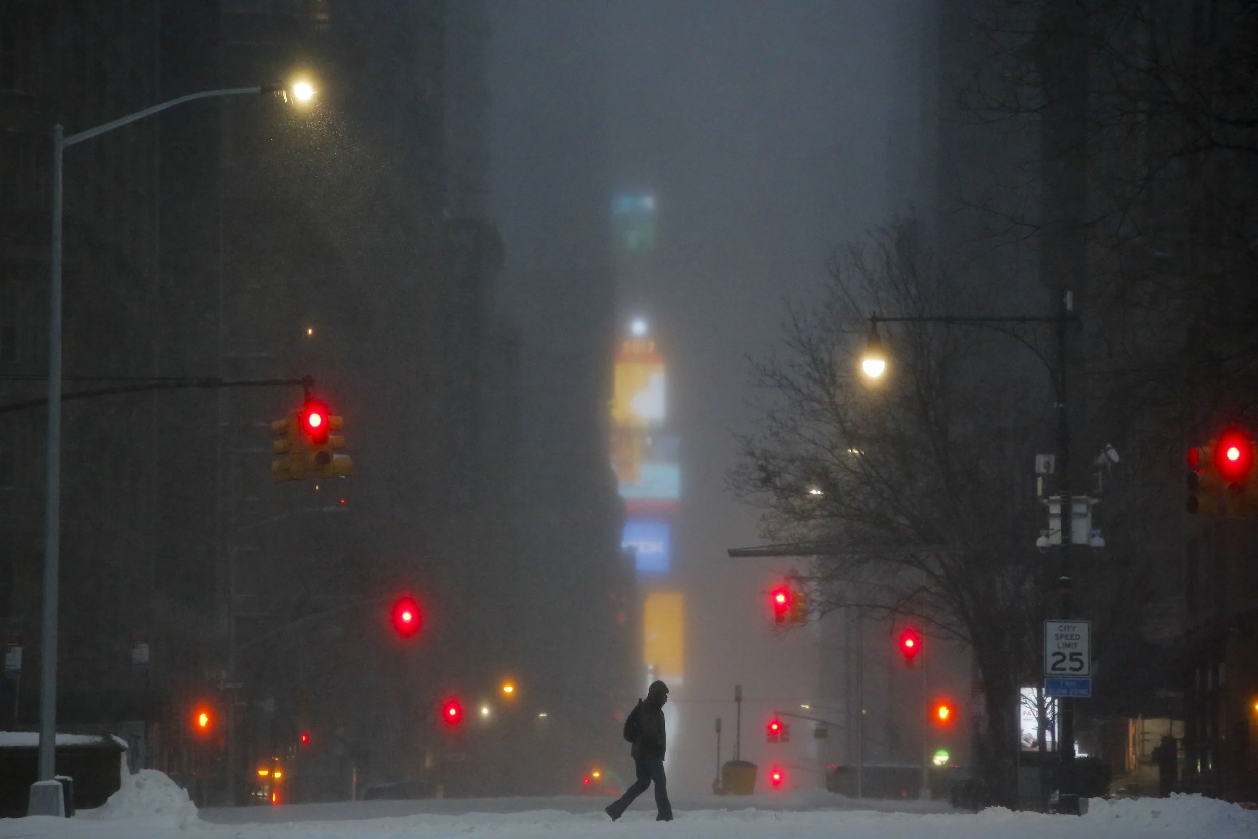 A pedestrian crosses 7th Avenue the morning after a snowstorm. 2017.