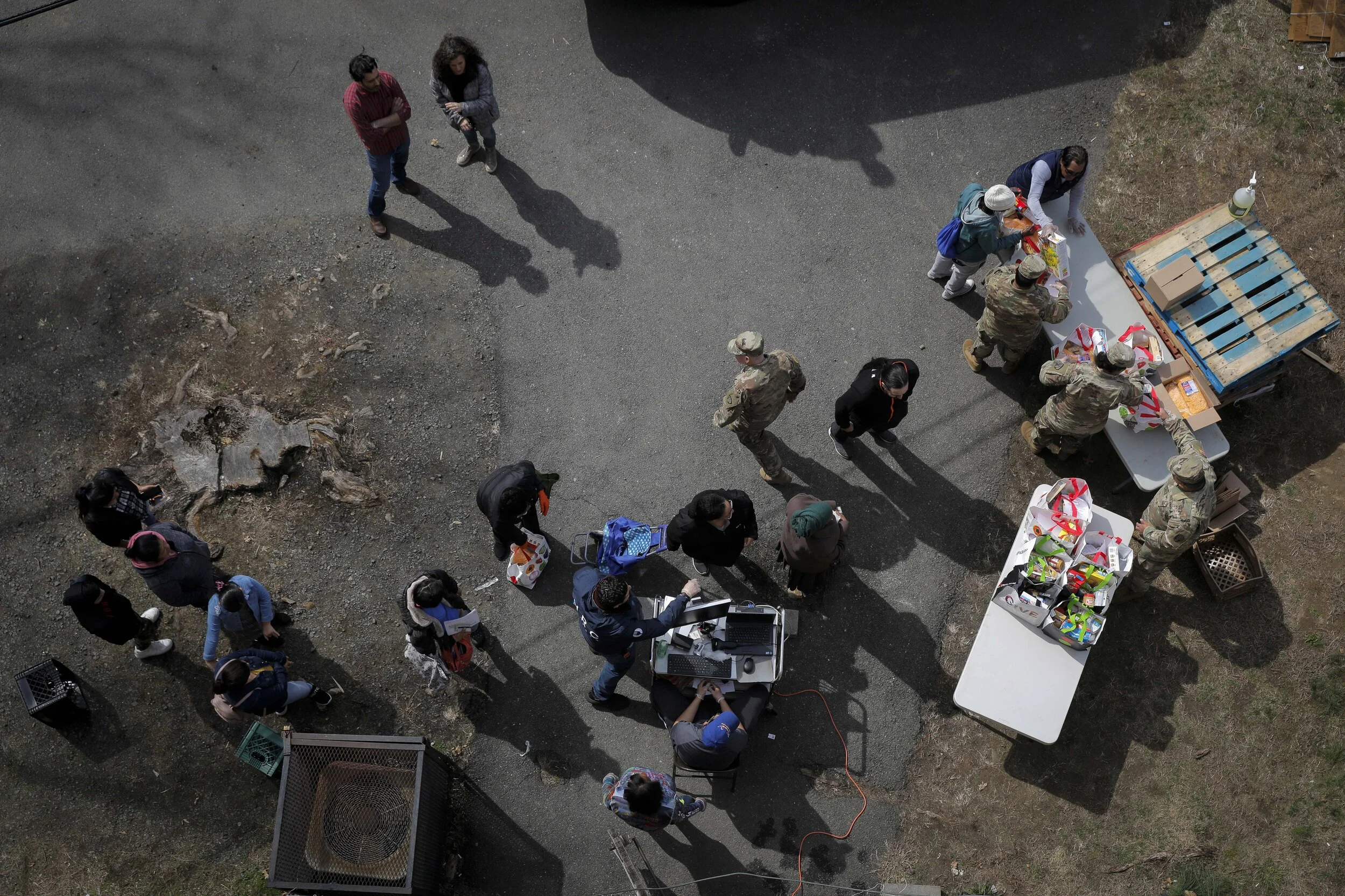  People queue for food distribution in New Rochelle, New York. Food lines appeared quickly as the gig economy ground to a halt due to lockdown orders administered to stop the spread of coronavirus.  